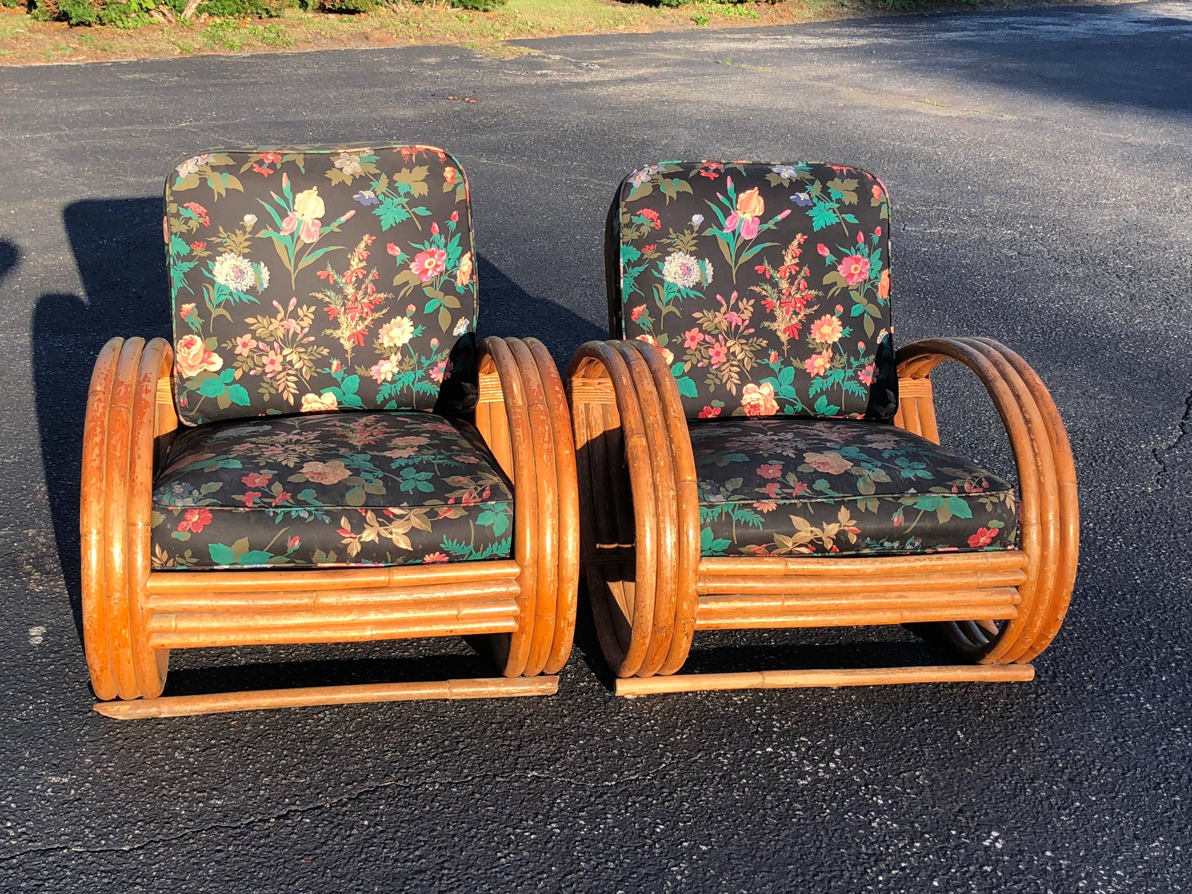 Pair of Rattan Lounge Chairs in the style of Paul Frankl. Reminiscent of his pretzel chairs and of Ritts Tropitan furniture. Heavy , solid cushions. Perfect for a screened in porch or veranda.