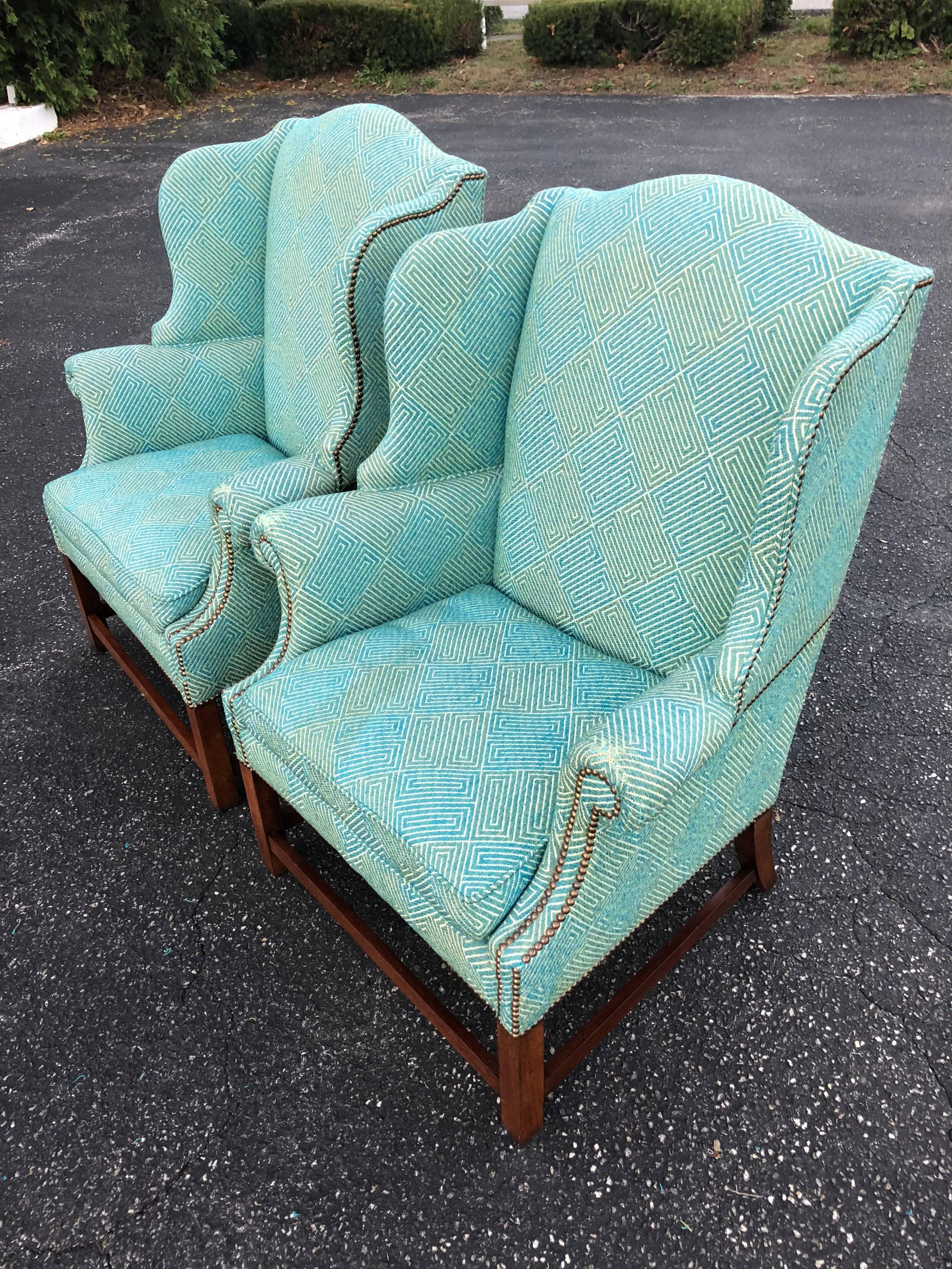 Pair of Henredon Wing Back Chairs in Turquoise. Fabulous fabric, just worn at arm rest ends. All brass tacks have been replaced. Strong and structurally sound.