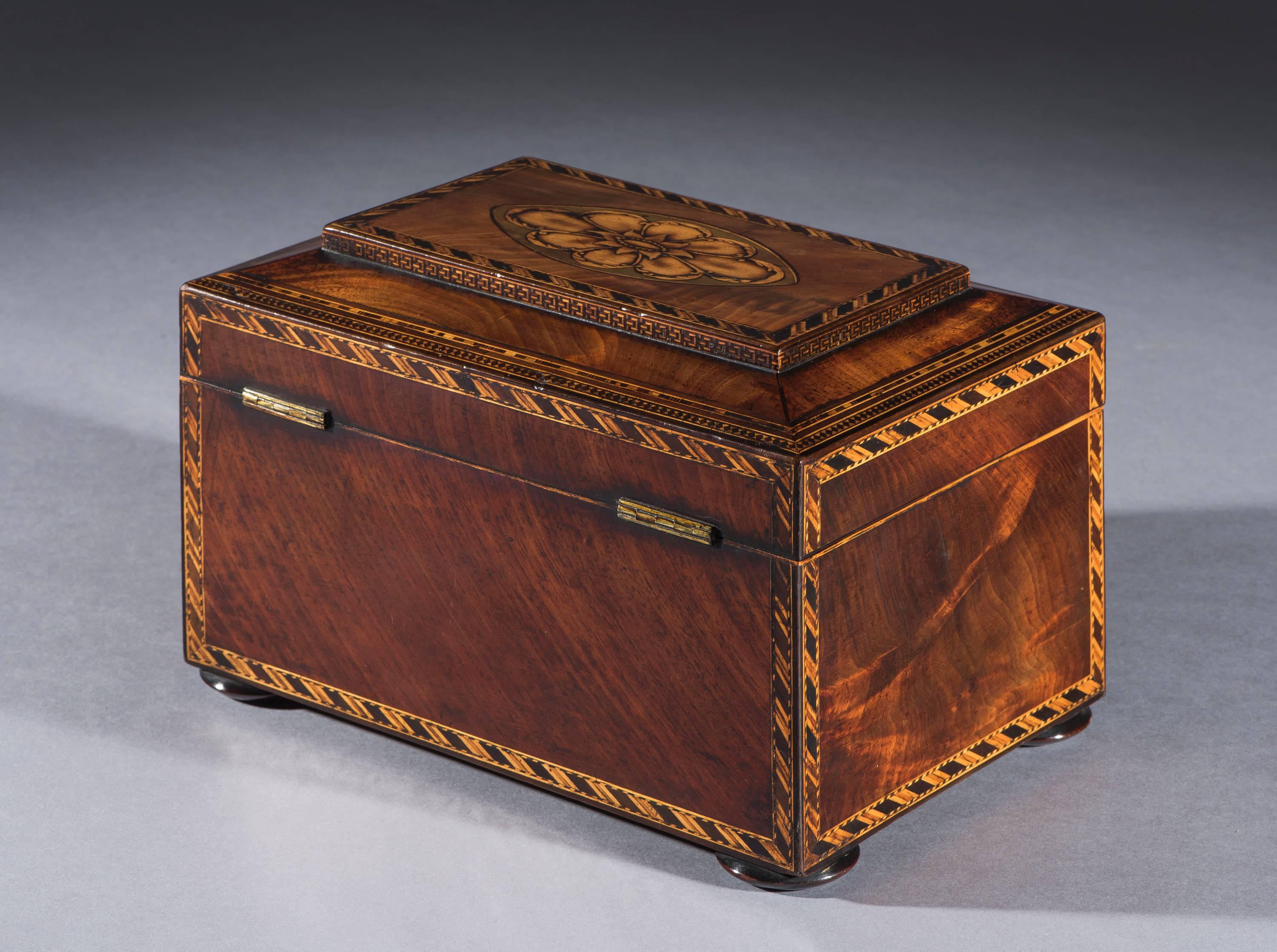 George III period flamed mahogany inlaid jewellery box.
The jewellery box has an inset mahogany tray and the original lining. It is fitted with an ivory lozenge-shaped escutcheon with the key and has gilt brass stop-lock hinges. The box stands on