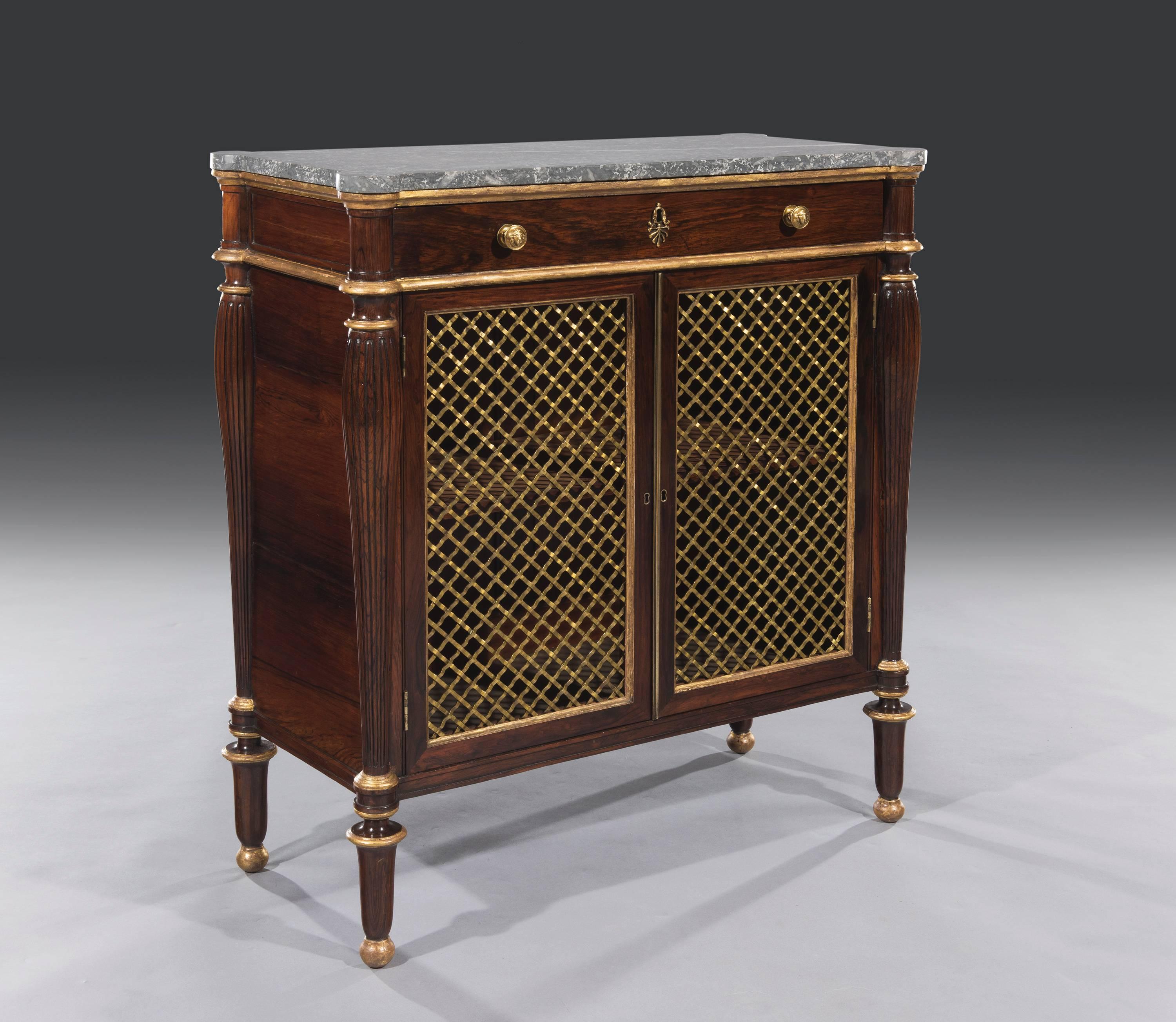 George IV Regency period rosewood marble-top cabinet.
The small elegant rosewood side cabinet with a rectangular shaped 'St Anne' marble top sits below water gilded mouldings and a full length mahogany lined drawer. The shaped bulbous columns Stand