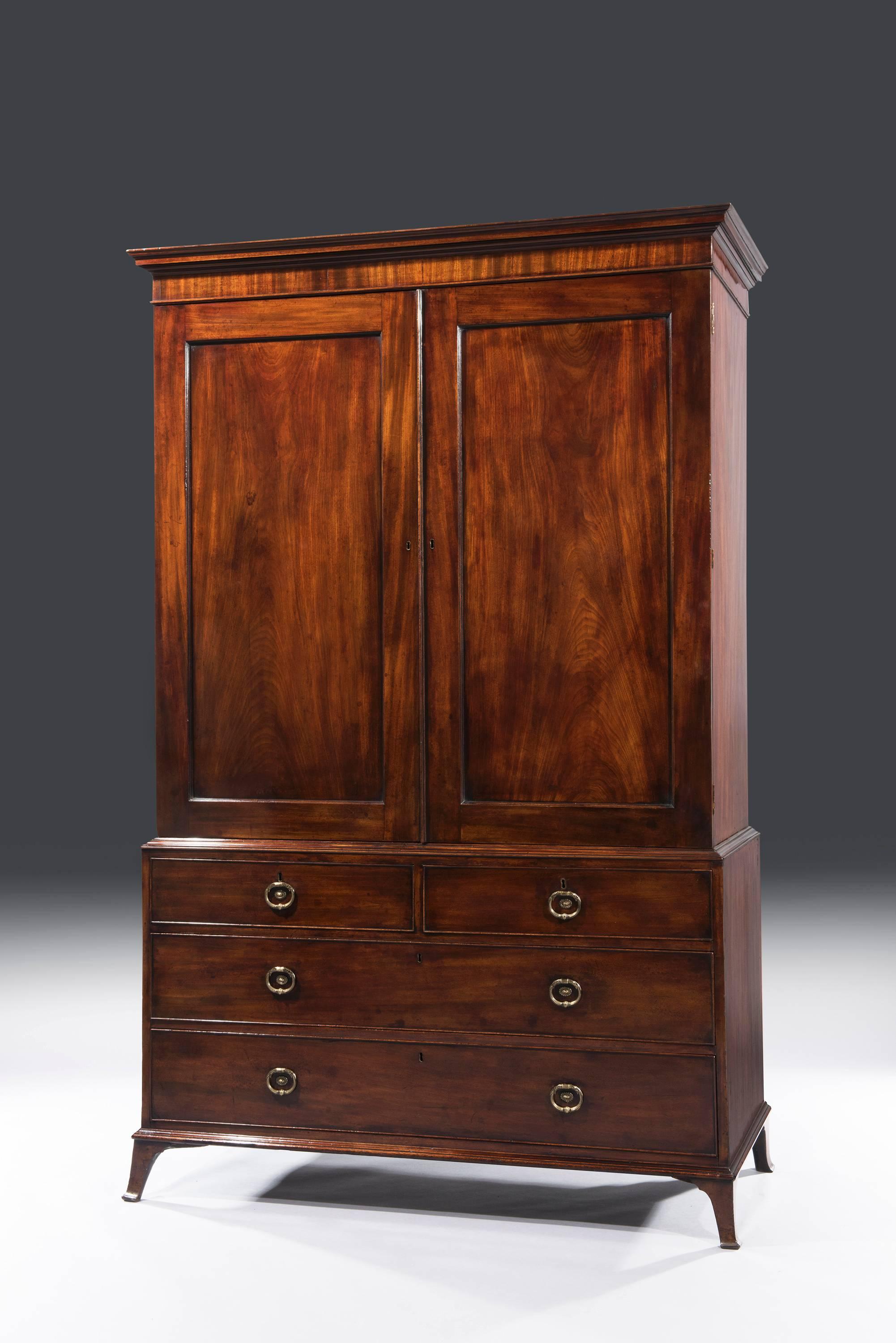 18th century George III Hepplewhite period mahogany linen press, stamped Gilllows of Lancaster. The linen press has solid mahogany moulding above two short and two long drawers that carry the original Gillow gilt brass oval shaped handles with