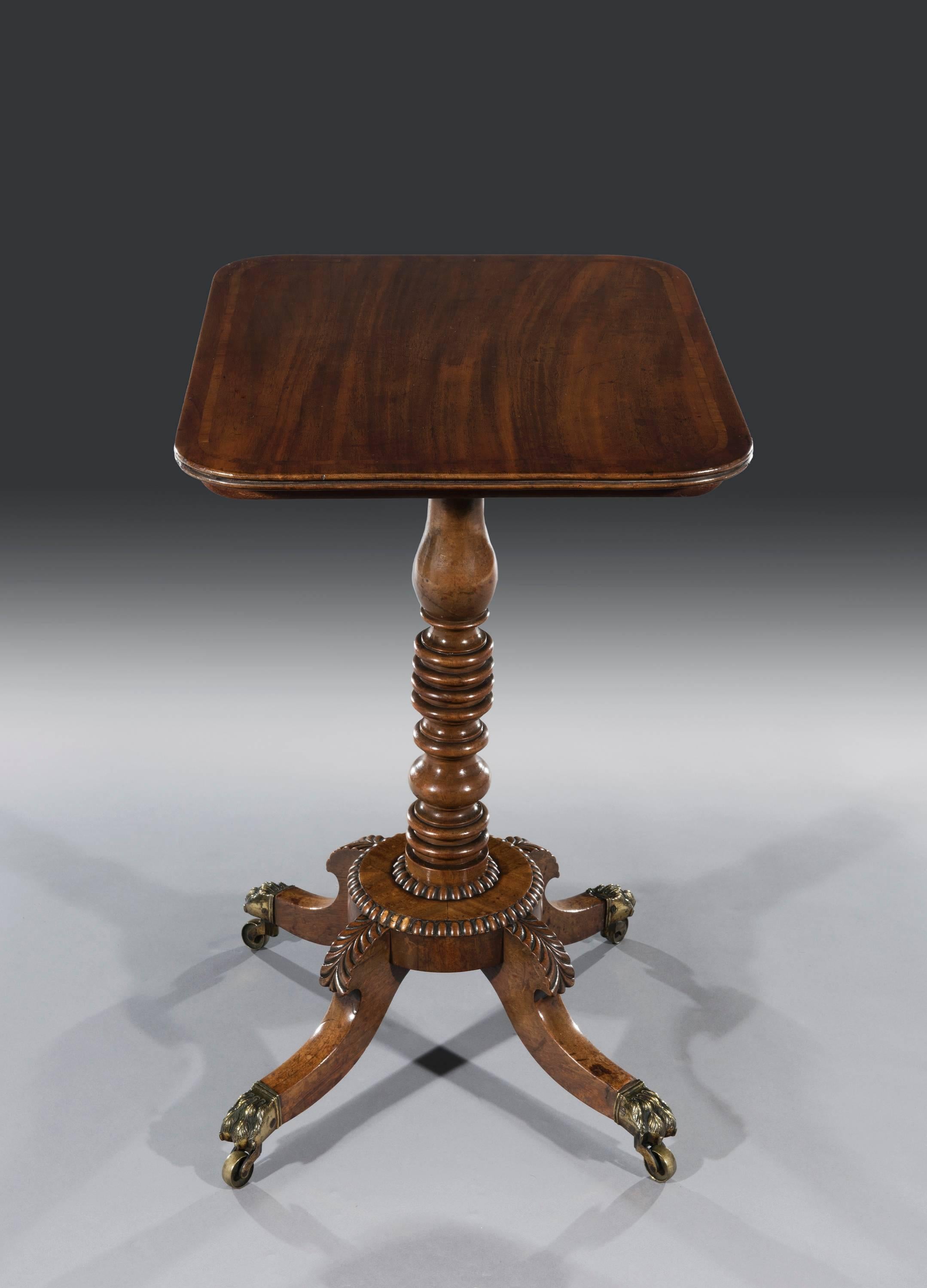 Small Regency Period Mahogany Tilt-Top Single Pedestal Occasional Table.The rectangular top is cross-banded in mahogany with a split moulded edge above a turned solid mahogany pedestal which stands on a circular platform base. This has gadrooned