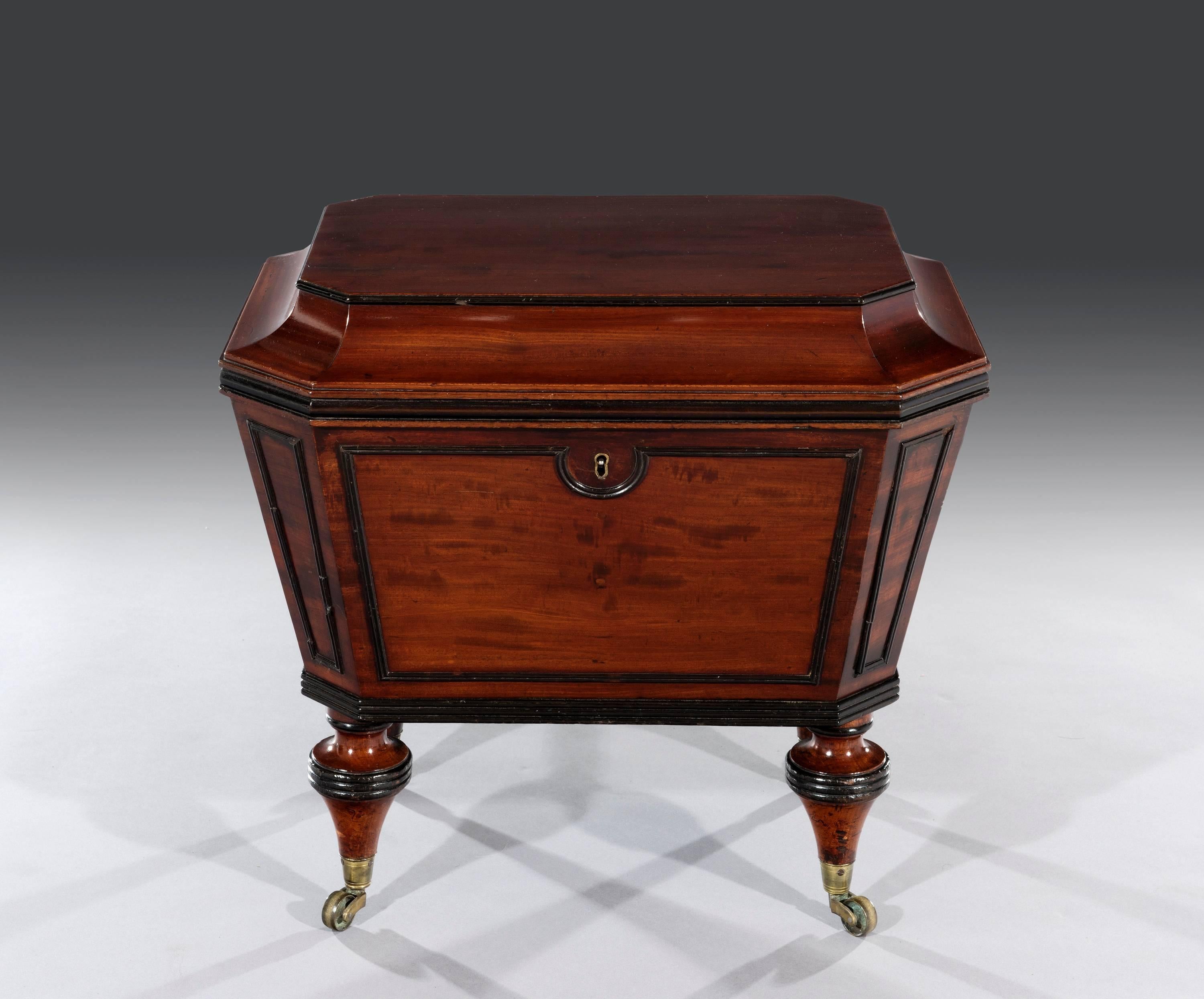 The small flat rectangular mahogany caddy top lid with ebonized mouldings sits above Fine reeded moulded panelled sides with the original fitted lock and lead lined divided interior.

The cellarette is quite unusual standing on its original toupe