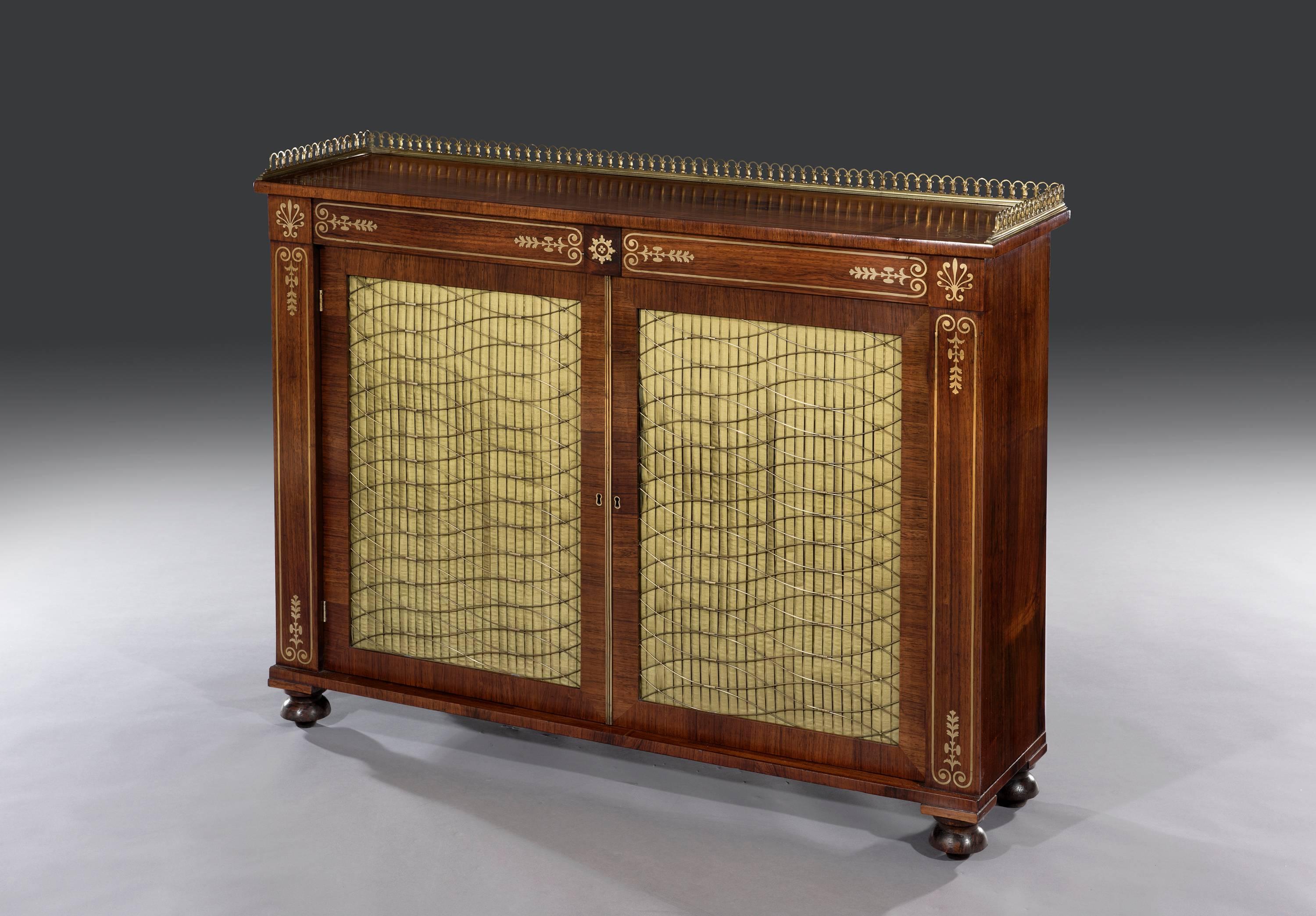The rectangular brass inlaid top fitted with the original triple plinth fleur-de-lys gallery sits above two mahogany lined drawers. The brass decoration to the cabinet is of London quality and has been expertly cut and inlaid. The cabinet is fitted
