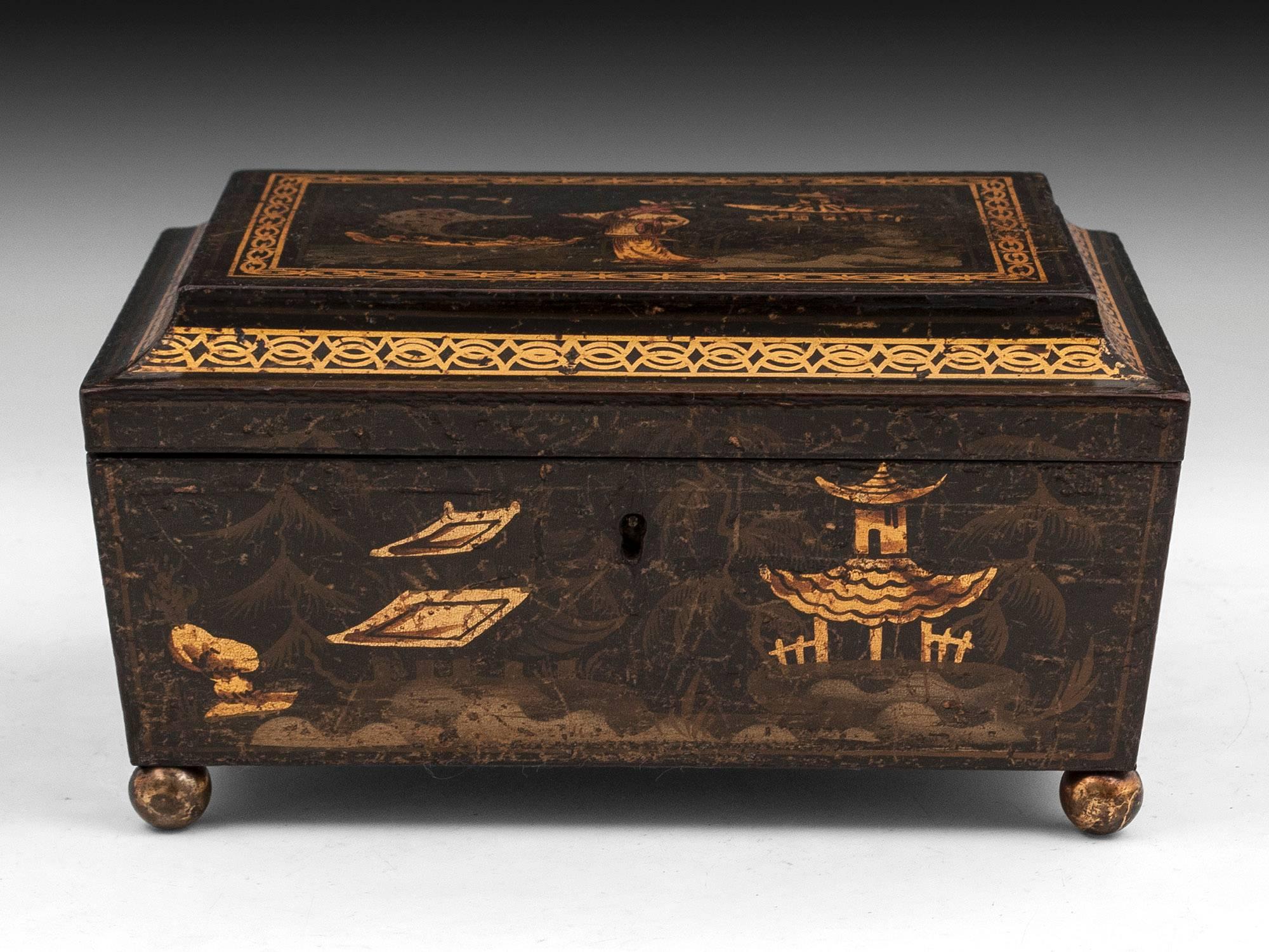The sewing box has naive decorations of landscape scenes and a figure on the top.