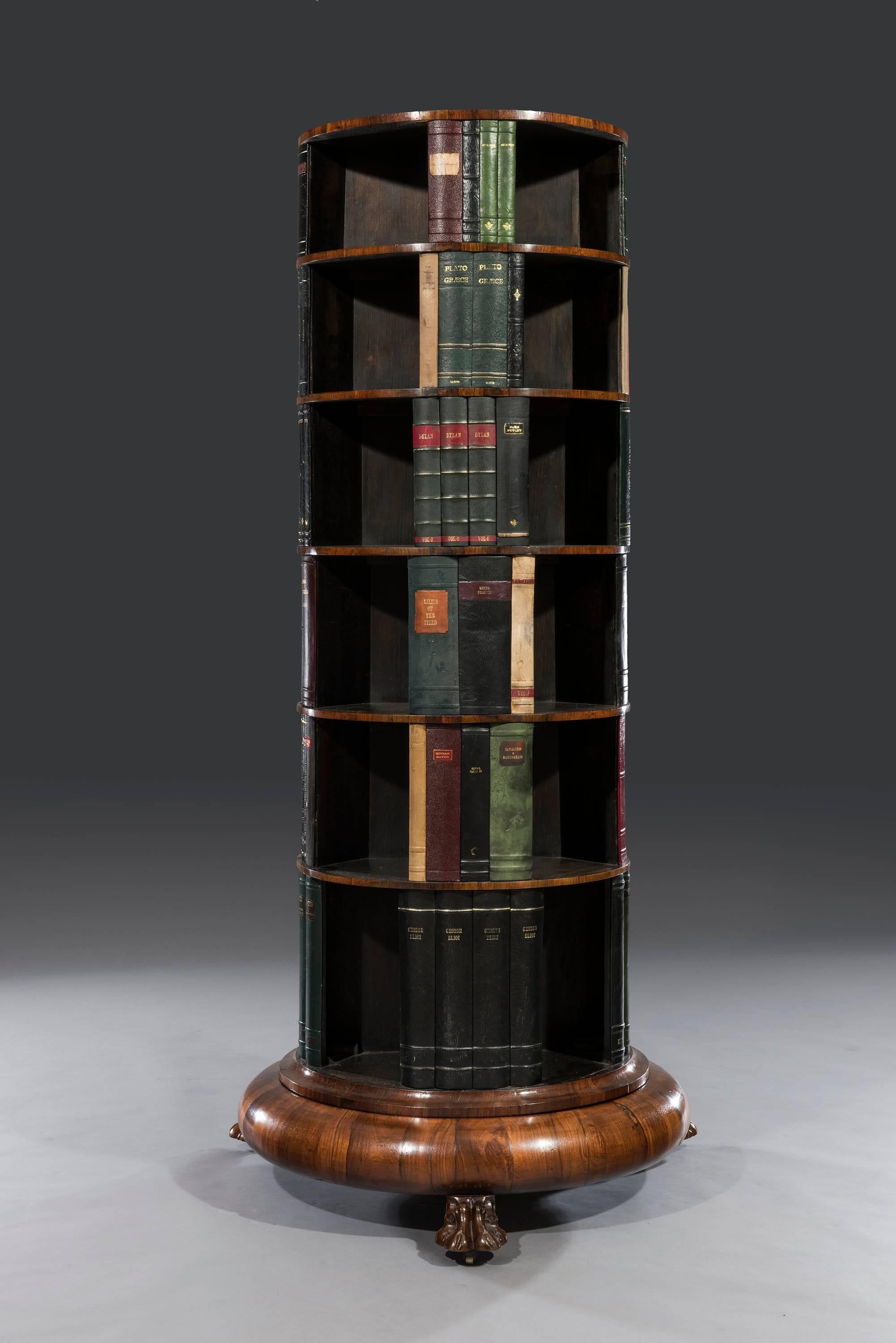 Rare George IV late Regency period circular rosewood revolving bookcase

The faded rosewood top sits above six graduated tiers with later replaced dummy books as divisions and open bookshelves. The bookcase rotates on a rosewood veneered base and