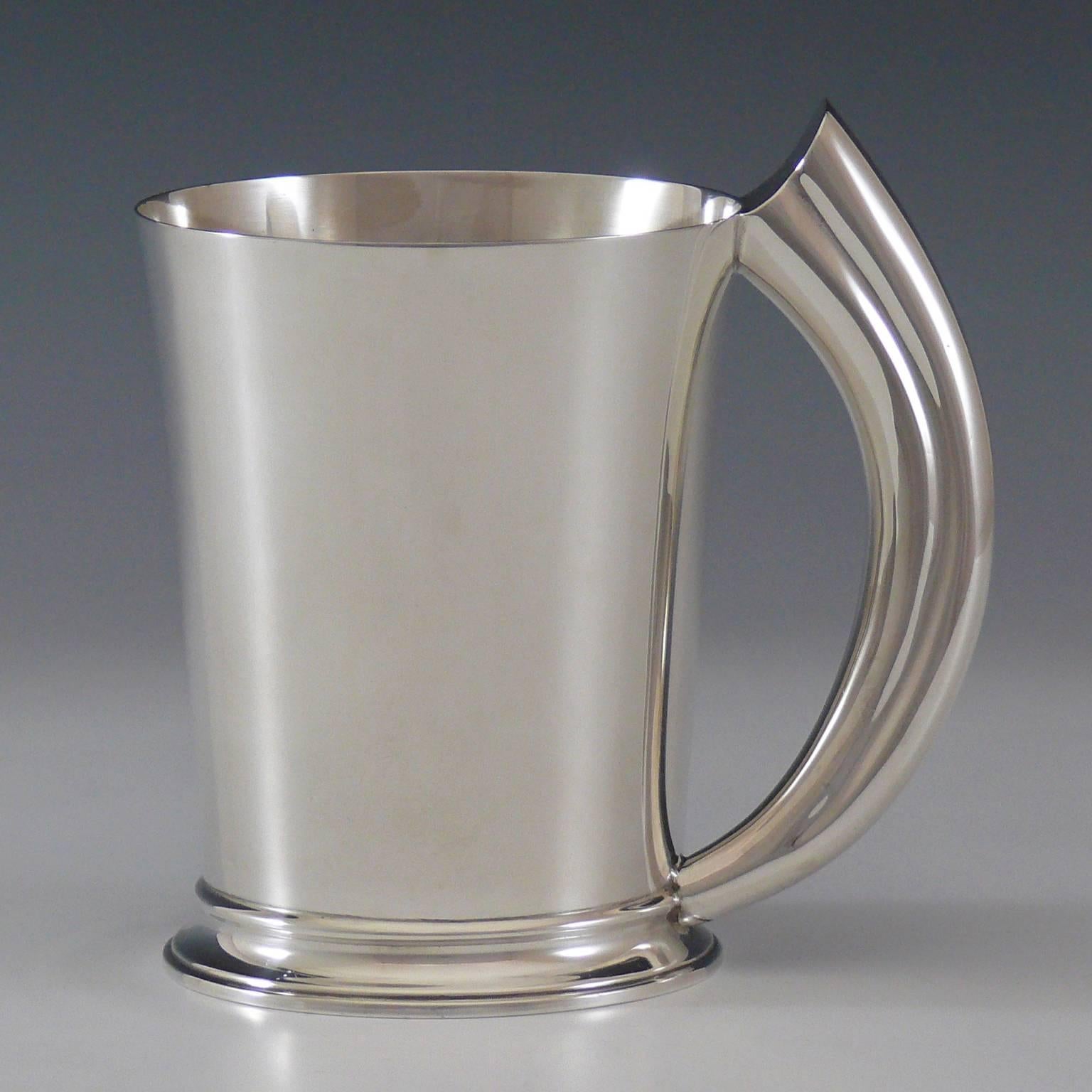 A wonderful Sterling silver tankard by Garrard & Co with shaped silver handle modelled after earlier boars tusk handle tankards that Garrards made at the turn of the 19th-20th century. Hallmarked Birmingham 1979 and with full Garrard’s makers and