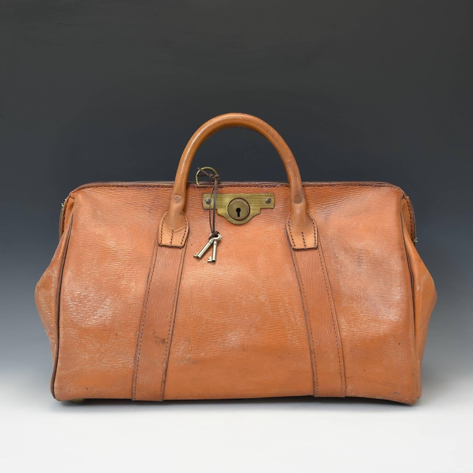Unusual British banker's cash bag in sturdy leather with ‘straw grain’ finish excellent condition in the style of a Gladstone bag. Has original leather interior and brass lockable catch with keys, circa 1950.

Bentleys are Members of LAPADA, the