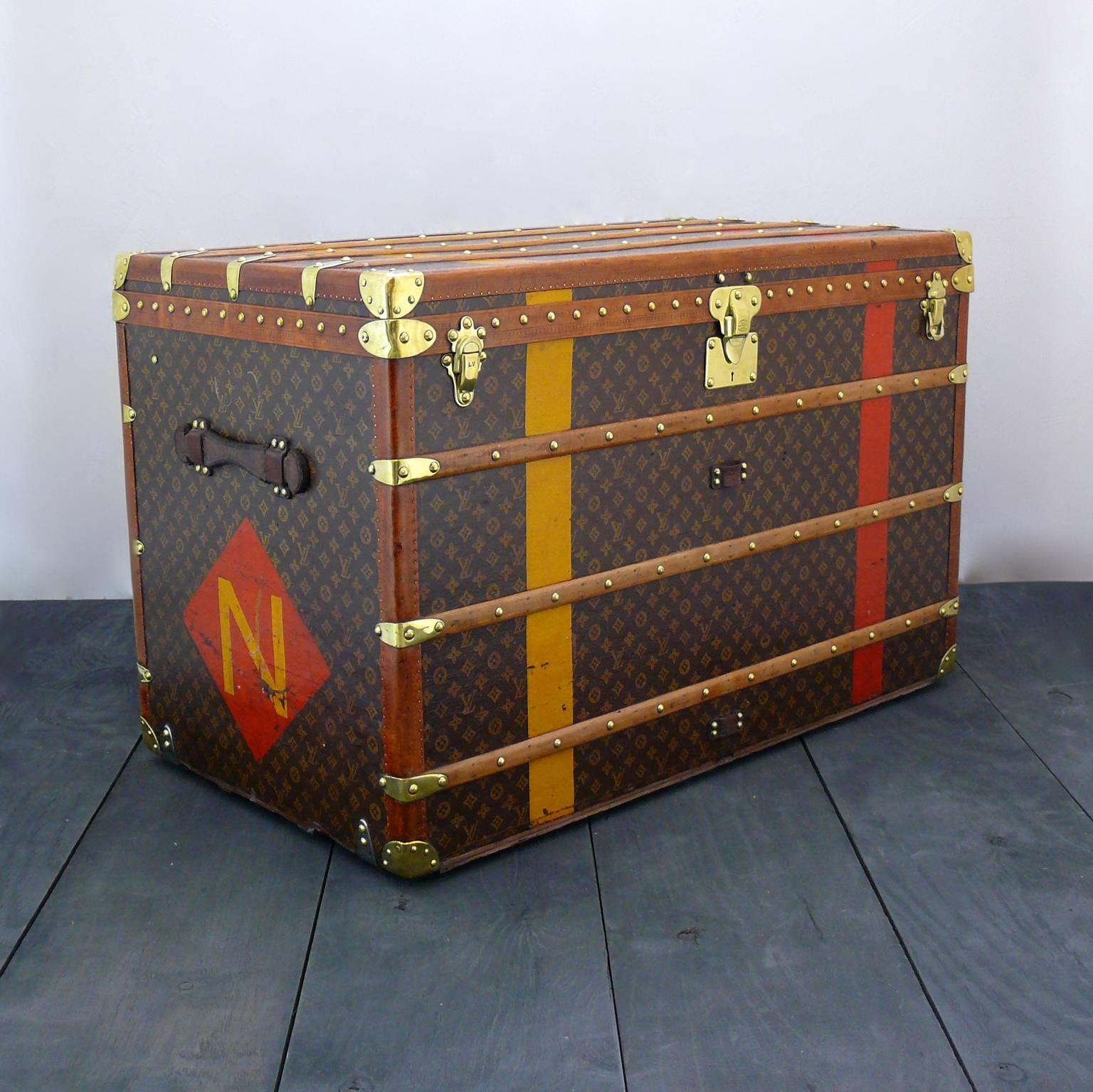 A splendid larger size Louis Vuitton steamer trunk with lozine trim to the edges, brass fittings, leather handles and both of its trays to the interior; circa 1916. The interior cotton lining to the base has been replaced to match the