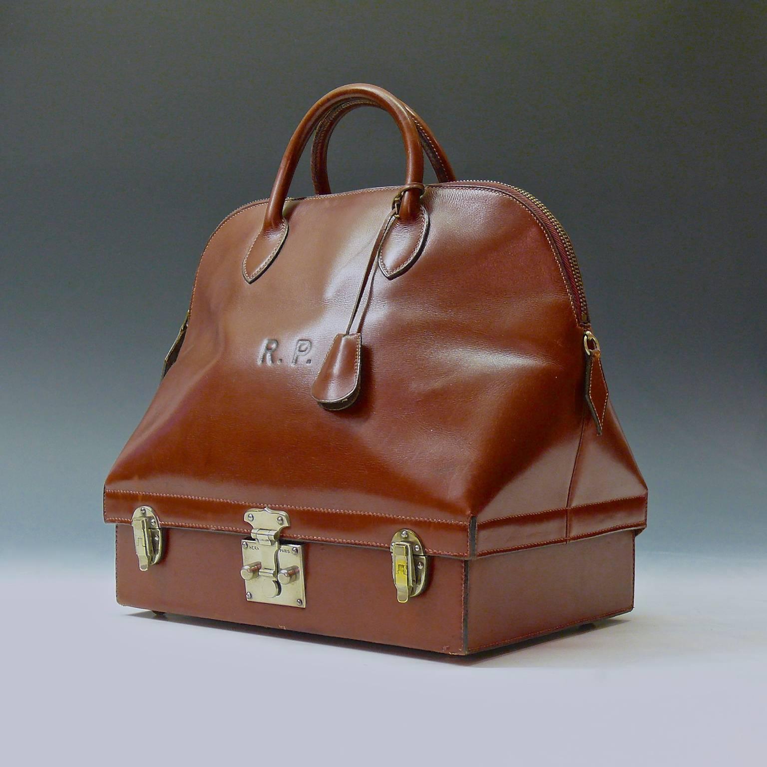 A stunning leather Hermès bag in a Mallette style, circa 1935. Very much the precursor of the Hermès Macpherson, there is a separate compartment, with nickel plated brass lock and catches, beneath the zipped bag section. Included is the original