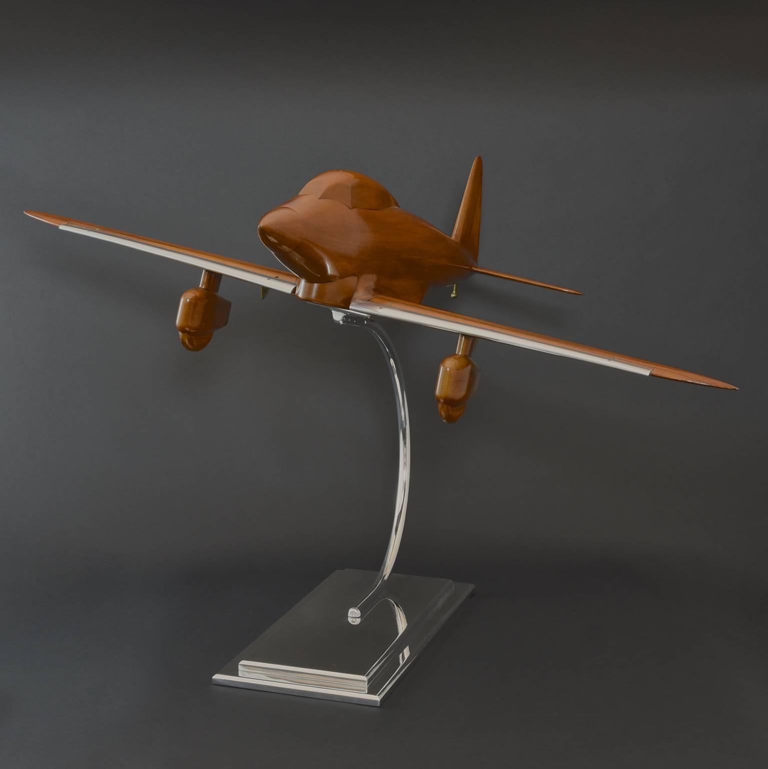 A stylish, large-scale Italian walnut Art Deco influenced wind tunnel aircraft model with metal details and moving wing and tail flaps, circa 1935. With a wingspan of 110cm and standing 64 cm tall, this model has great impact. Newly mounted on a two
