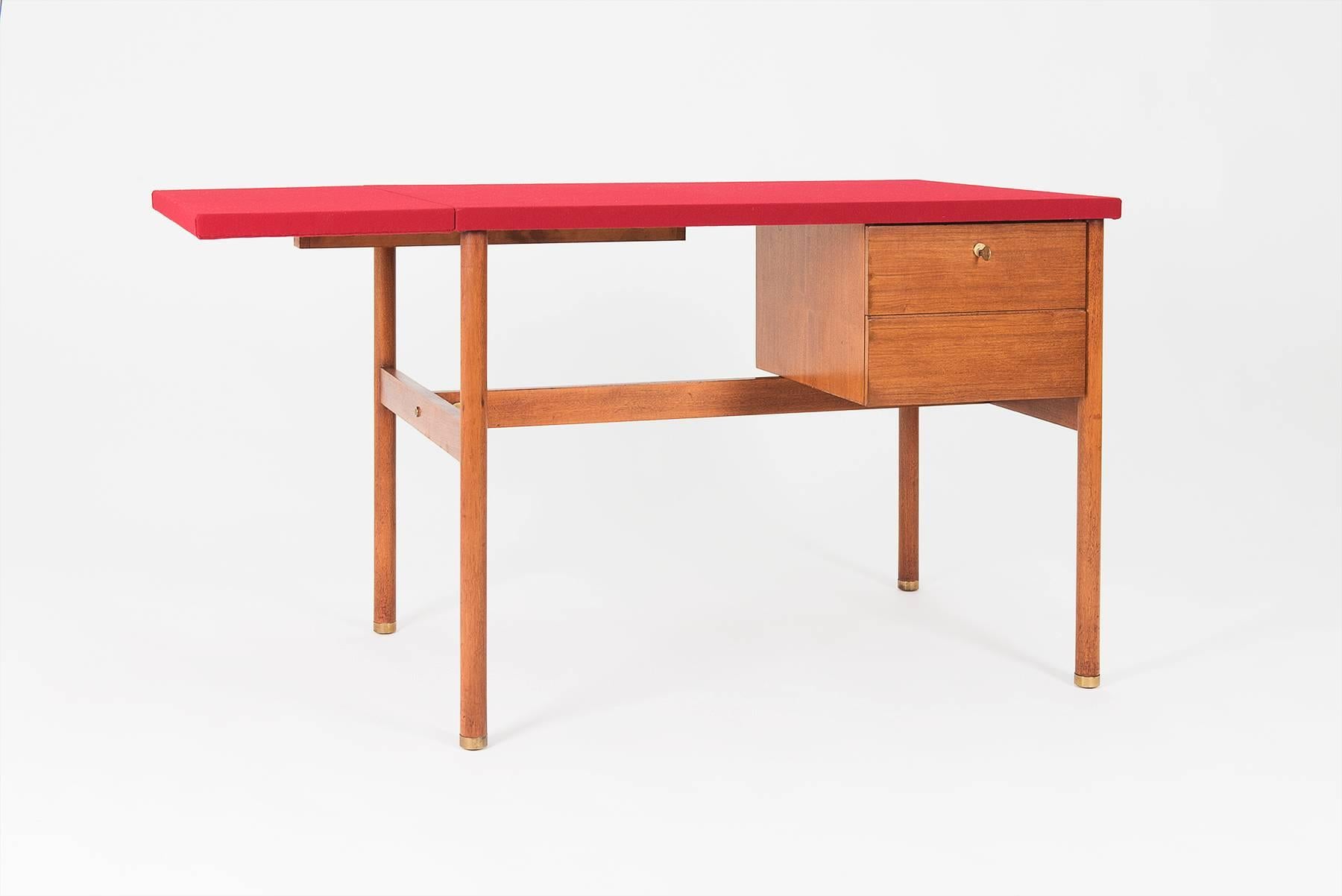 Elegant two-drawer desk designed by Josef Frank for Frangi, Italy, in 1957. The structure is made in walnut with brass elements and feet; the left end of the top, which is entirely covered with red cloth, can be easily tilted.

Dimensions:

cm