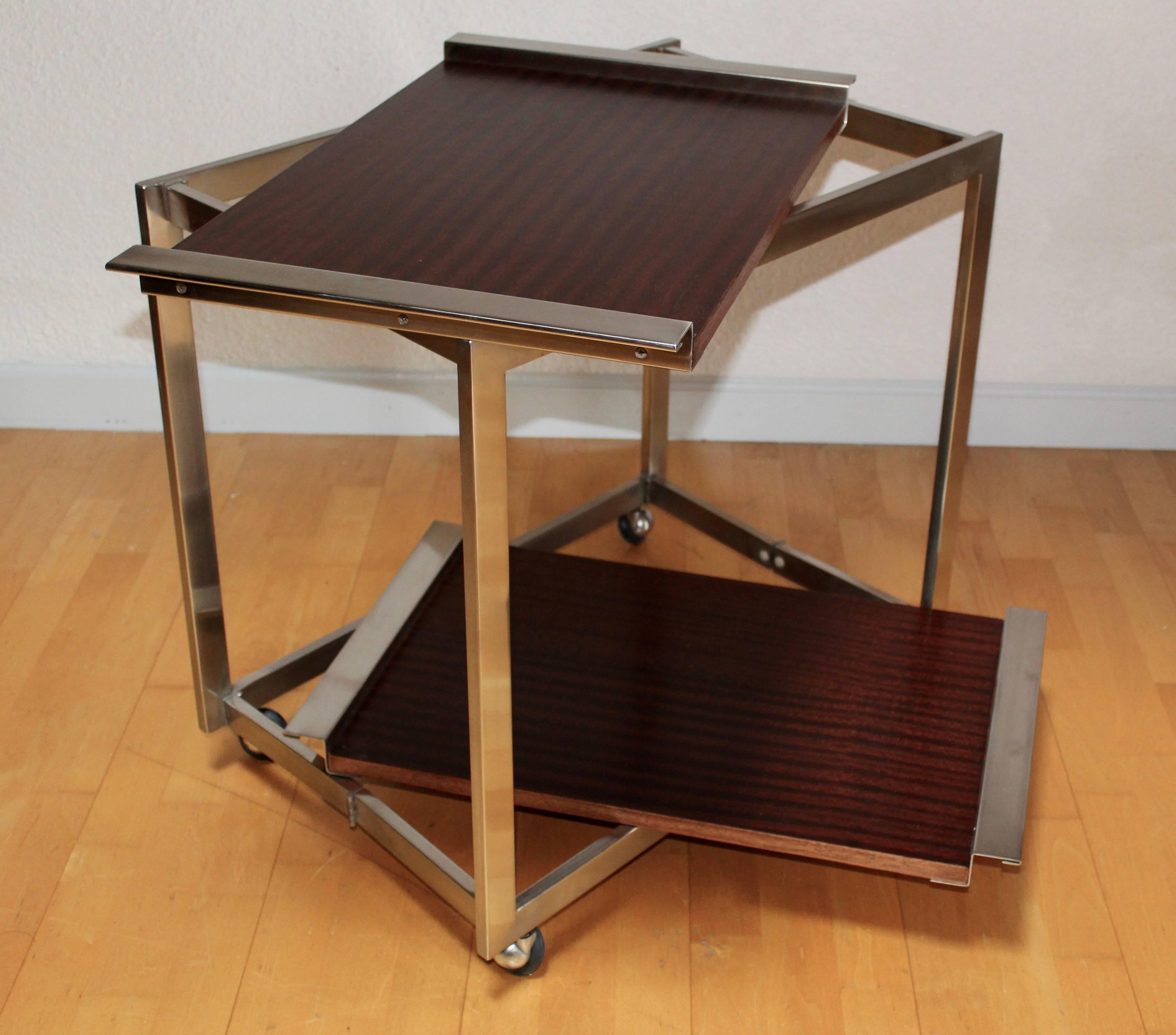 Folding trolley in brushed and polished steel; removable mahogany trays for EFA
France, circa 1960.