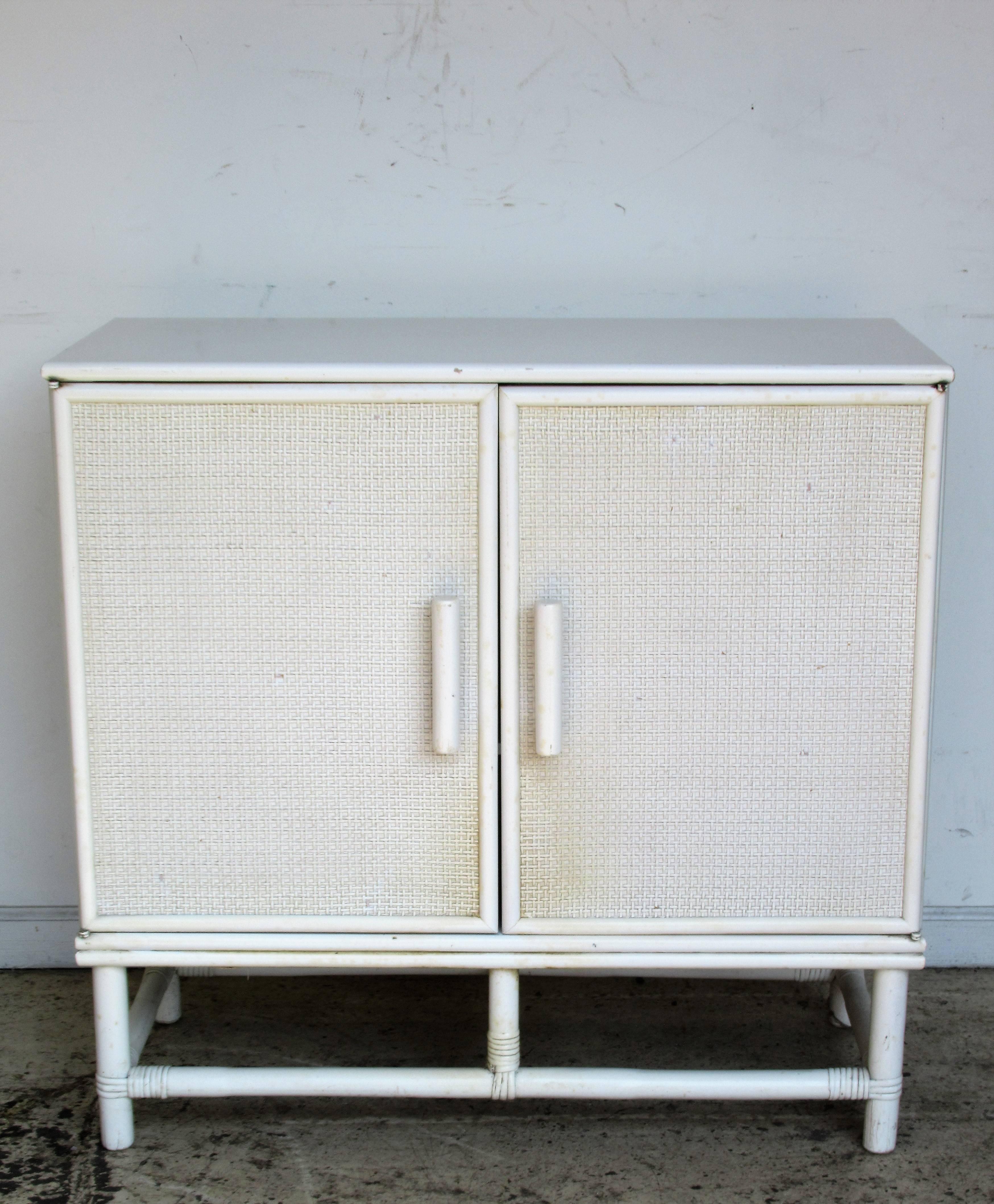 Mid-20th century minimalist two-door cabinet with open interior fitted for adjustable shelving. Original white enamel painted finish is in good condition. A versatile design that can be used in many different ways. Very high quality heavyweight