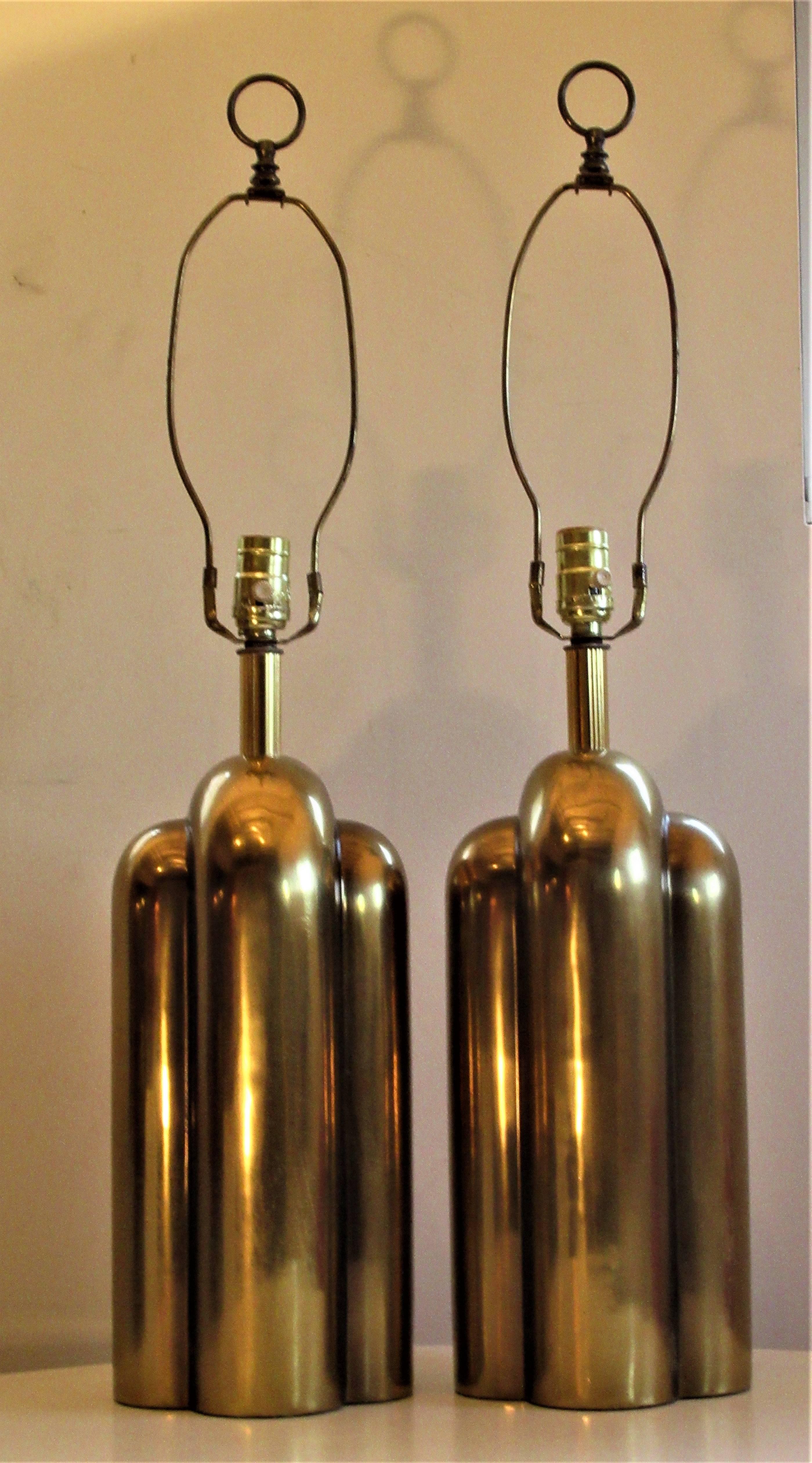 A great looking pair of sculptural bullet shaped modernist brass lamps in the Art Deco style by Westwood industries, circa 1970.