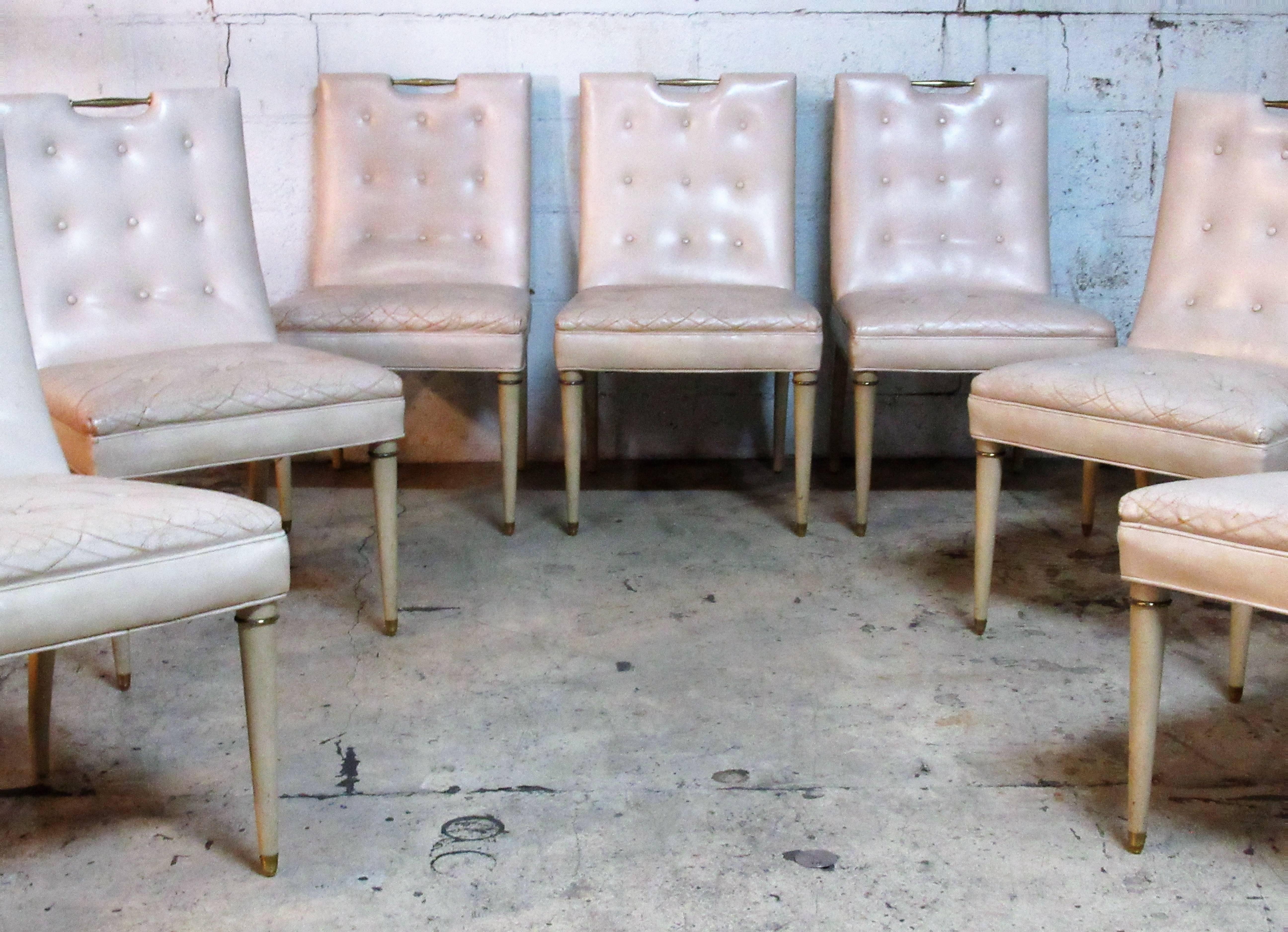 A set of eight all original early Hollywood Regency dining chairs with very pale pink leather button tufted upholstery and a bone colored parchment finish to the brass-mounted wood frame. Sleek sculptural glamorous and exceptionally beautiful. See