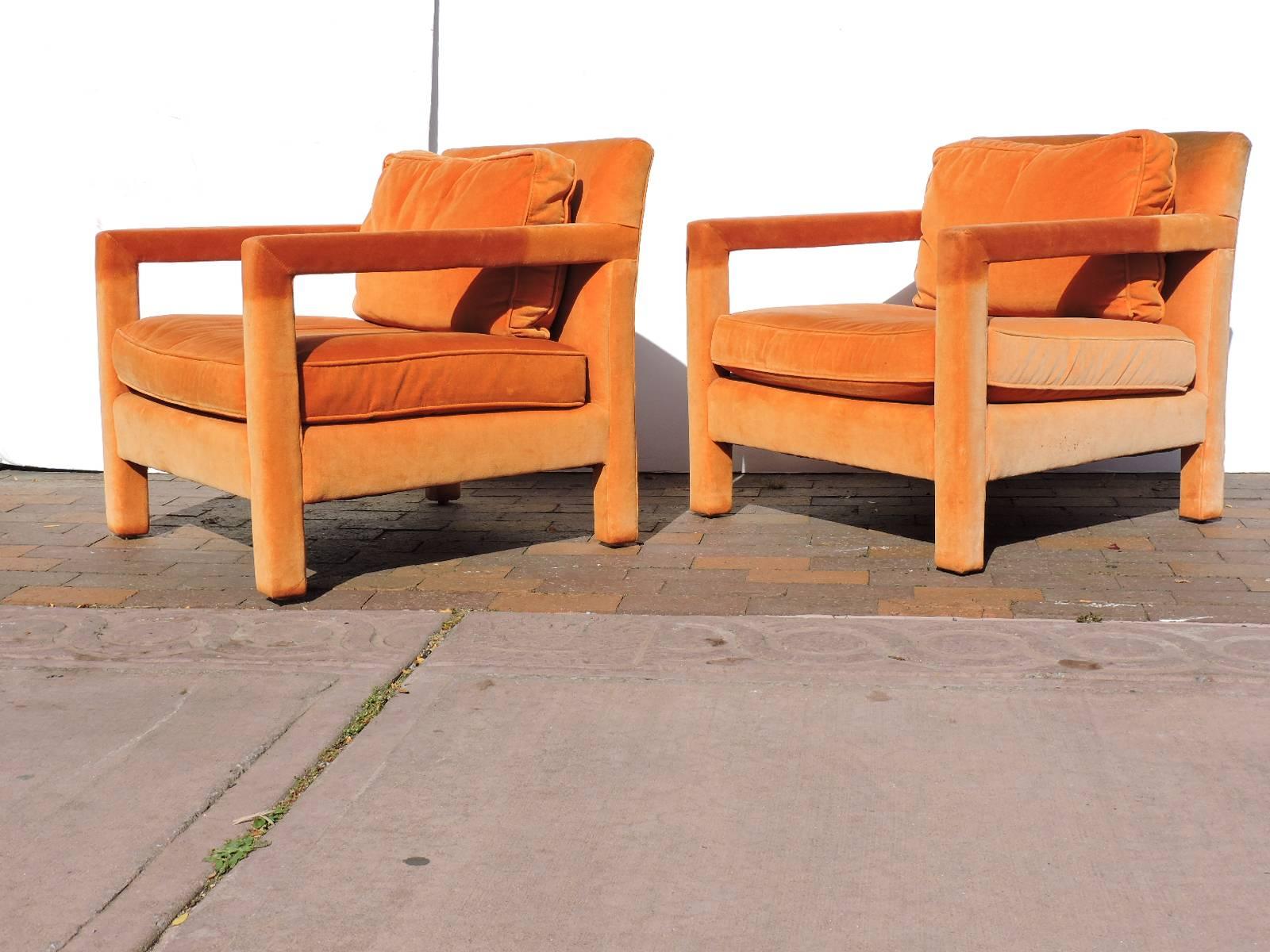 A great looking and substantial size pair of original tangerine orange blended cotton velvet felt fully upholstered parsons lounge chairs by Flair Division of Bernhardt Furniture Company in the style of Milo Baughman.