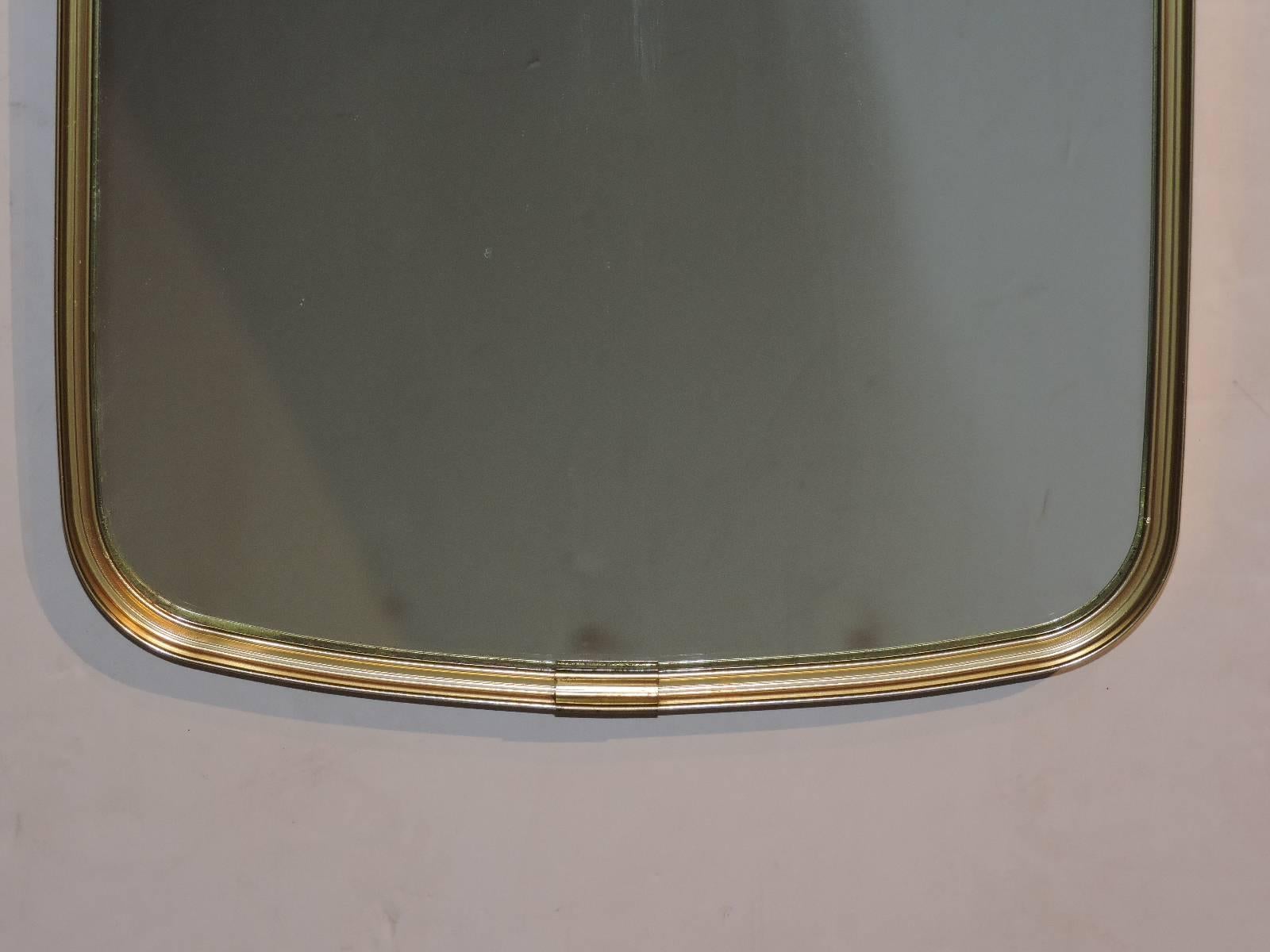 Modernist asymmetrically tapered oblong golden brass mirror that can be wall hung in the two different ways as shown in our pictures. In the style of Gio Ponti - circa 1960's