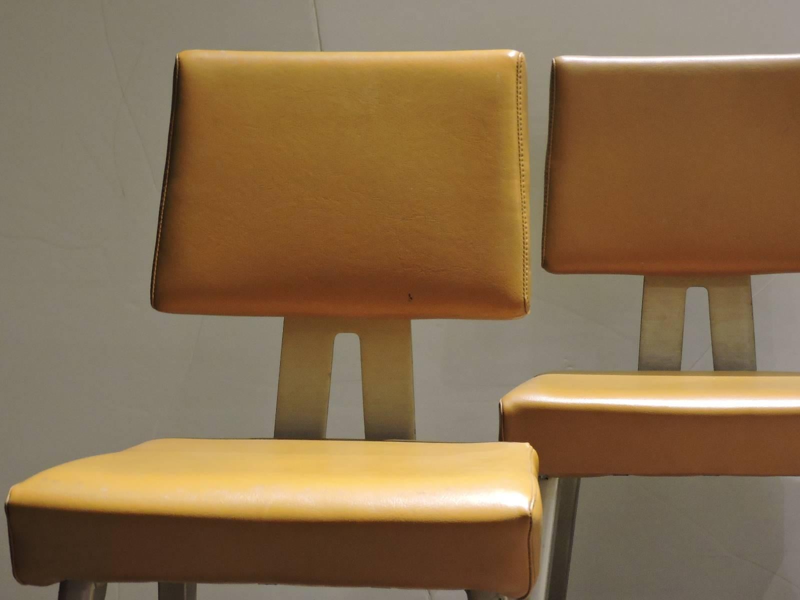 A very good pair of mid 20th century industrial General Fireproofing GoodForm aluminum task chairs in great all original condition right down to the period vibrant gold textured vinyl upholstery.
