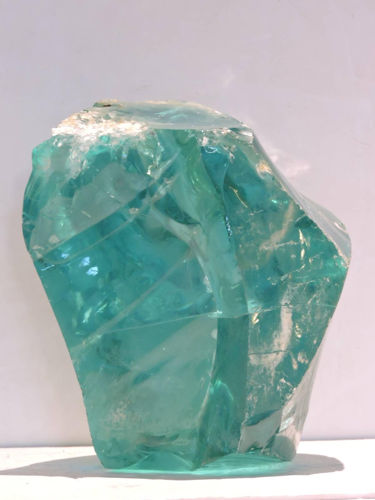  Massive and very heavy chunk of genuinely old free form transparent glowing deep aqua glass cullet. Can be placed in many different positions and weighs approximately 40 pounds. This is a great one.
