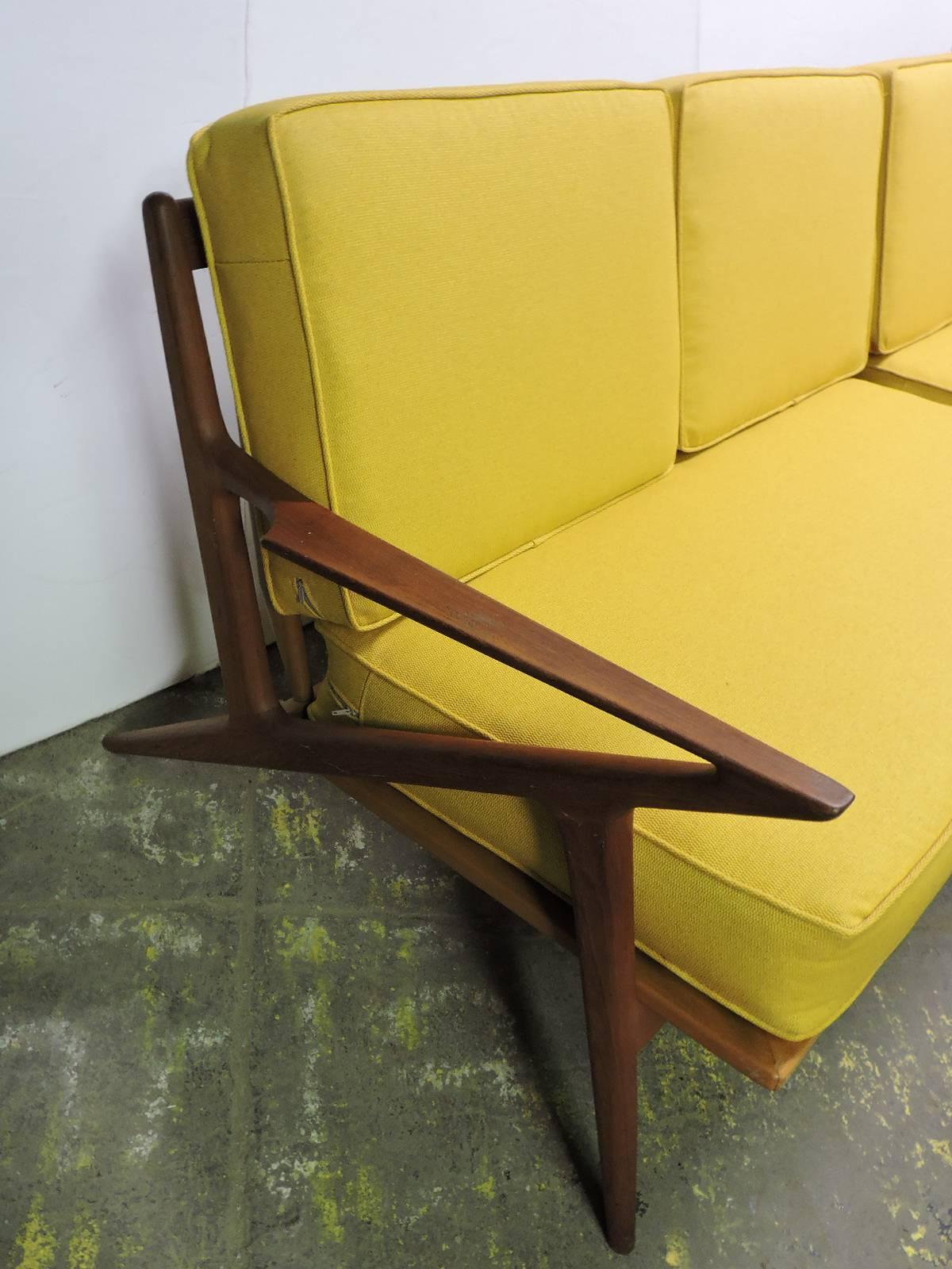 A rare two section Danish modern Z sofa designed by Poul Jensen for Selig with what appears to be the original factory brass bronze boomerang shaped brackets for added support where tapered legs are joined to frame ( see pictures) Just reupholstered