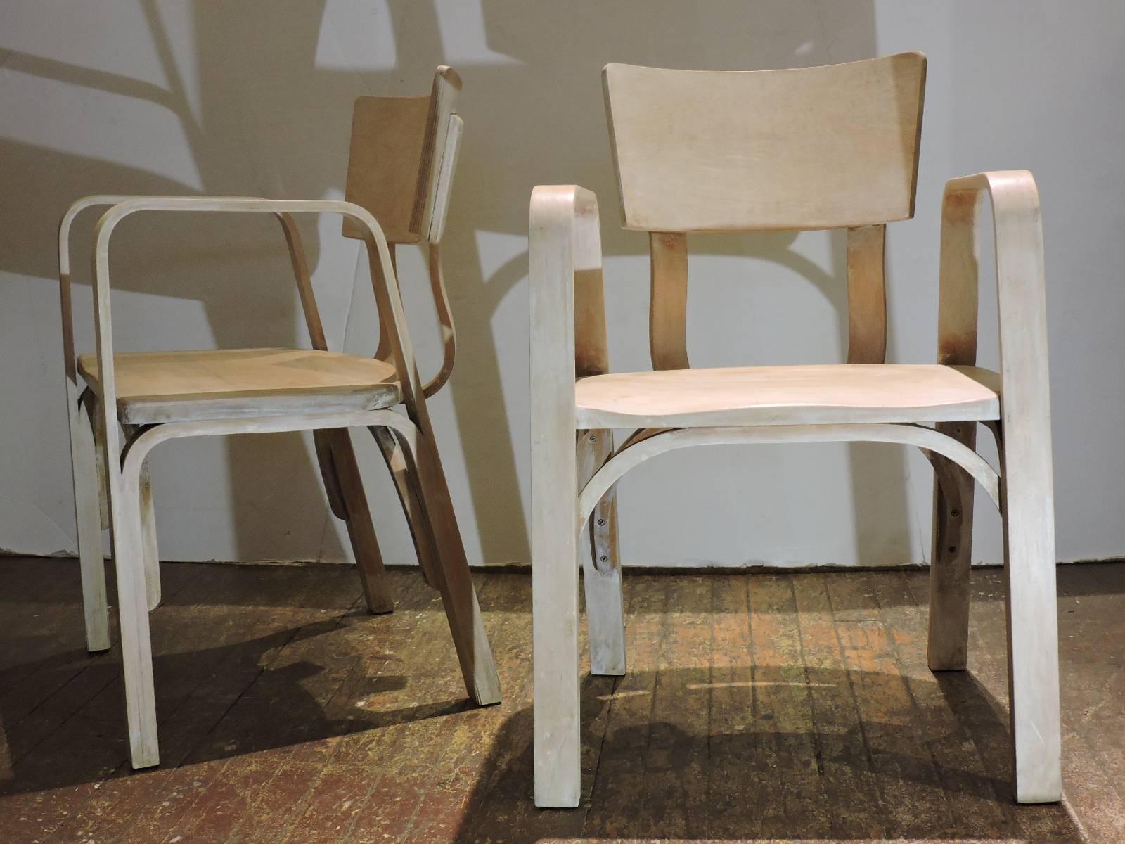 A good looking pair of mid 20th century Thonet bent laminated plywood armchairs in a bleached & limed pale parchment like finish. Stamped Thonet - New York under seats