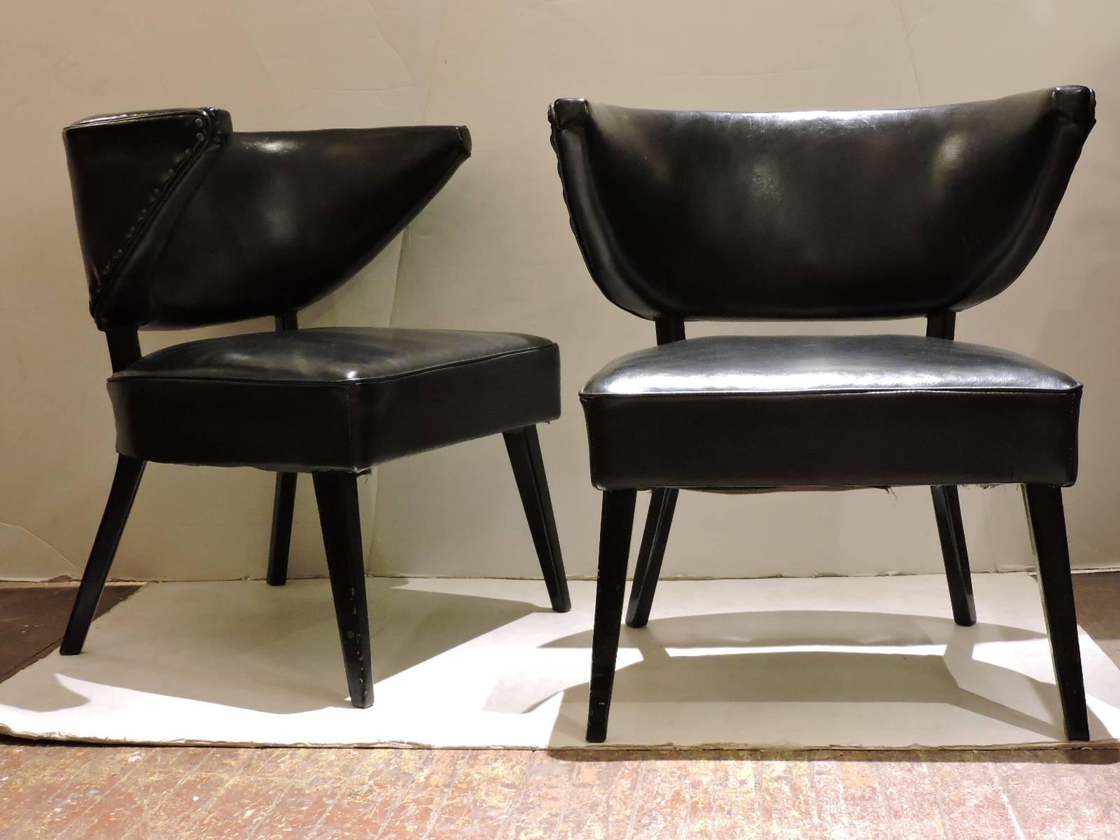 In the style of William Haines a pair of mid 20th century high style Hollywood Regency slipper type lounge chairs with beautifully tapered exaggerated winged backs.