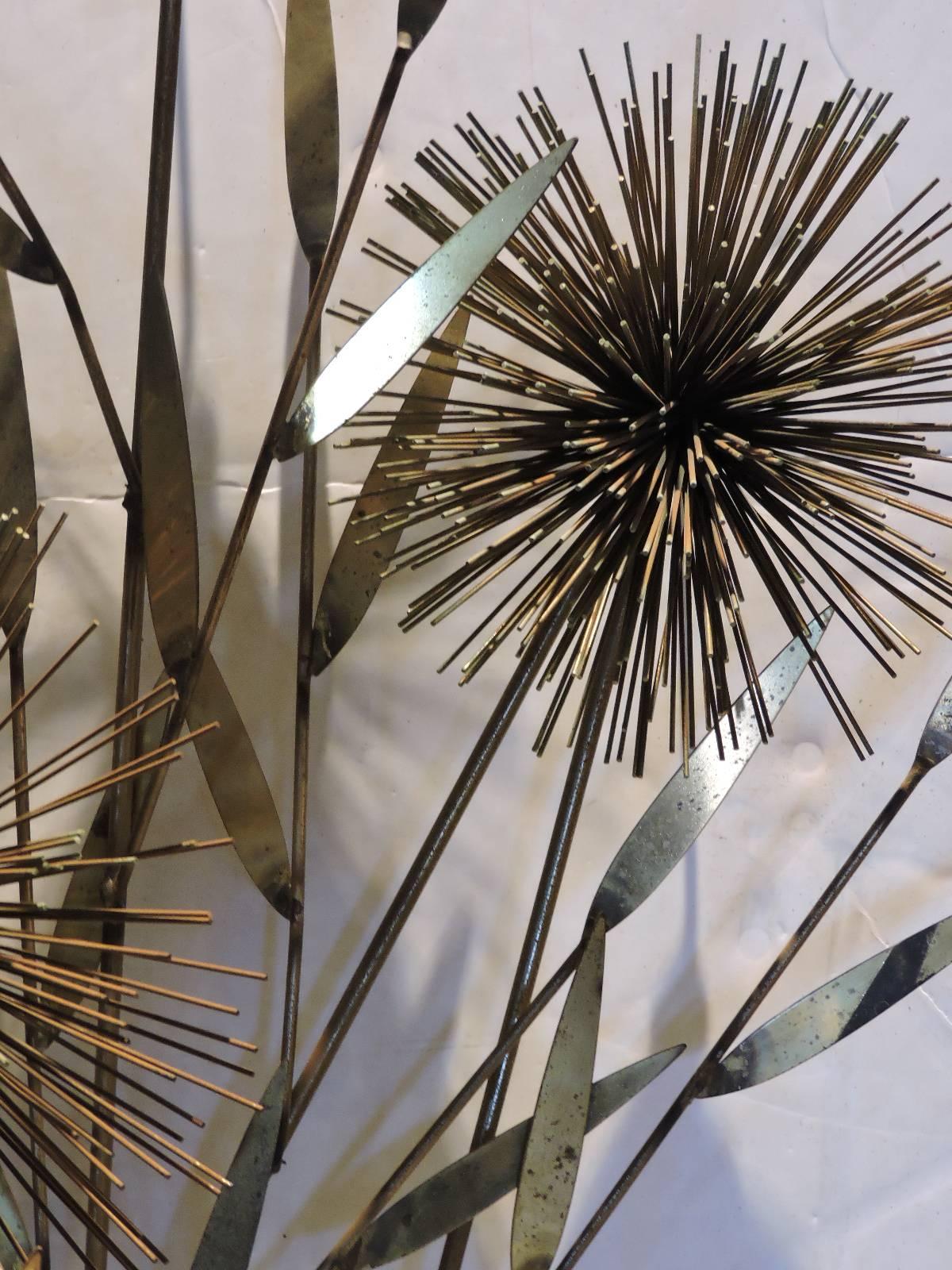 A large urchin pom pom tree wall sculpture by Jere. The brass in nicely aged original surface with some oxidation verdigris to finish - see all pictures. Retains the five original welded hanging hooks on back side.  Copyright signed and dated on the