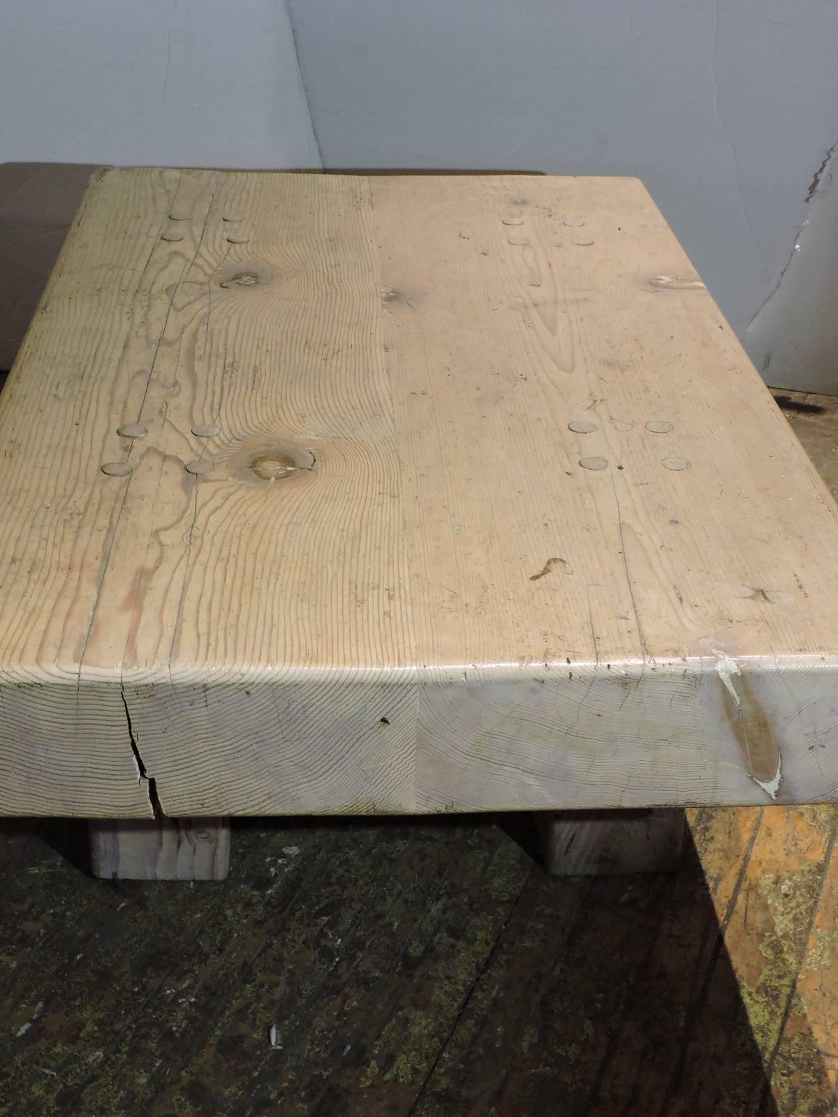 Artisan custom-made bleached and whitewashed coffee table with a five inch thick beautifully grained and knotted solid pinewood block top showing the circular doweled and pegged construction that joins the four square legs to tabletop. A great