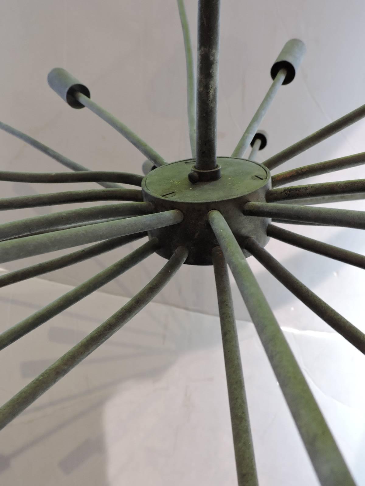 A great quality large architectural twenty-four-arm copper Sputnik chandelier with all-over naturally aged verdigris surface. A beautiful time worn sculptural mid-20th century object.