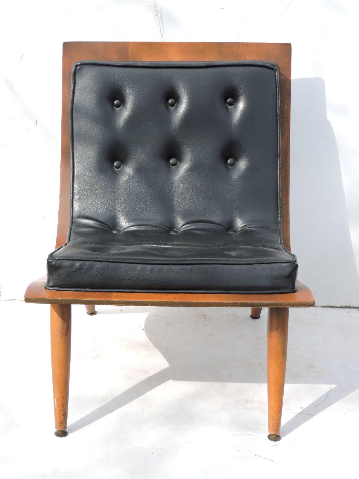 A pair of mid-20th century modern bentwood and button tufted black vinyl scoop lounge chairs manufactured by Carter Brothers in all original condition with nicely aged rich color patina to wood.