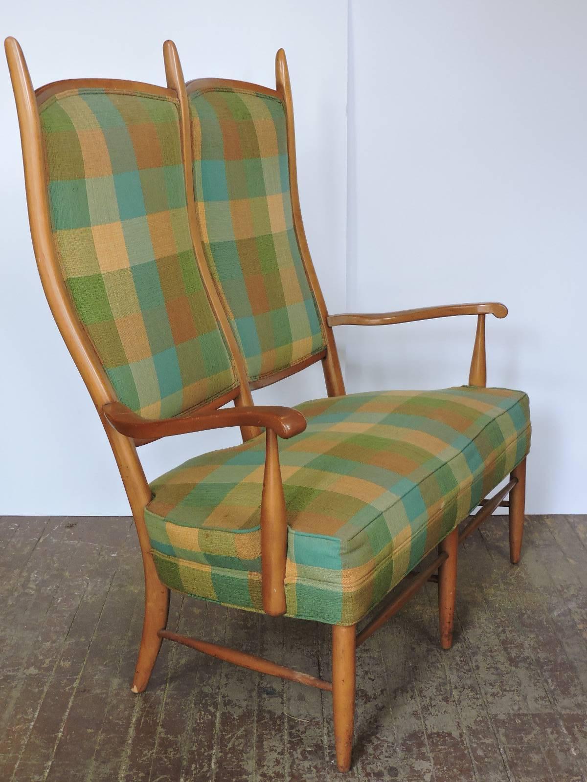 Attributed to Edward Wormley for Dunbar - a high peaked back maple framed two-arm settee loveseat in beautifully aged color patina to the wood and the original plaid upholstery, circa 1950-1960. No label present.