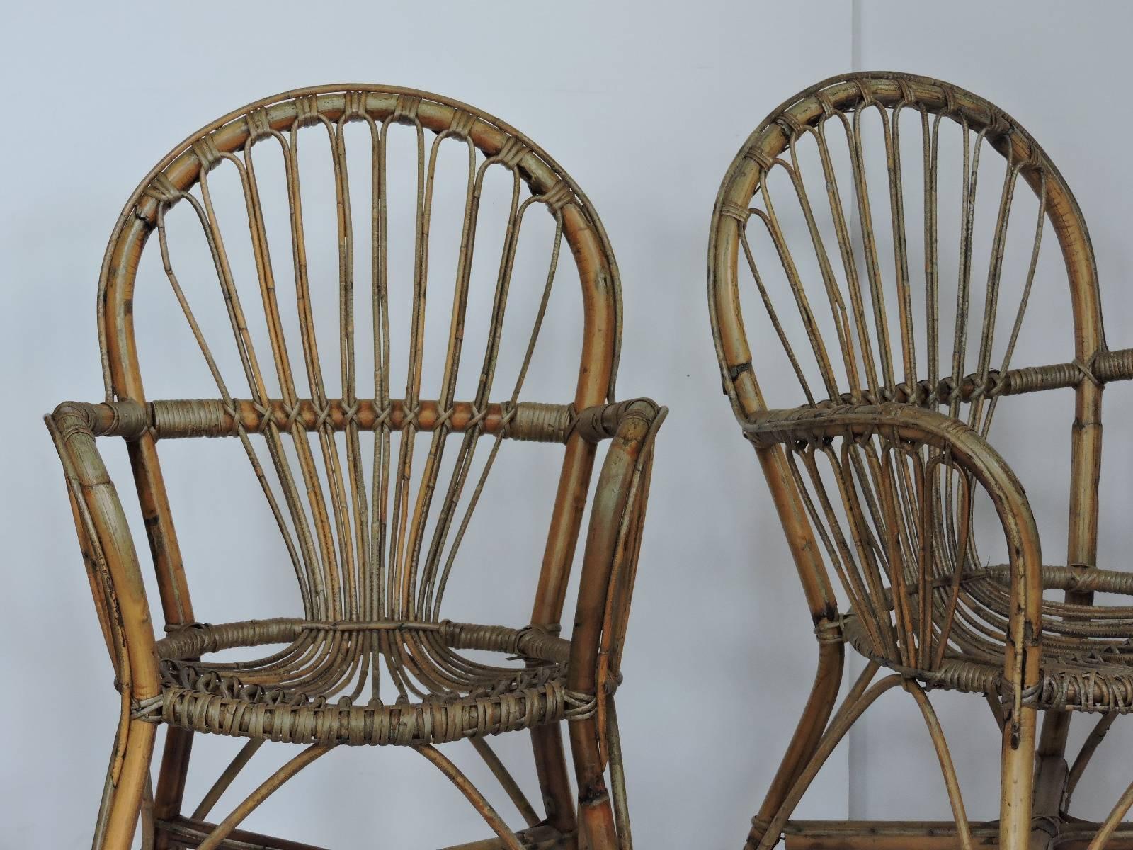 A good looking pair of mid-20th century natural rattan armchairs in the style of Franco Albini with beautifully aged surface color patina to reed.