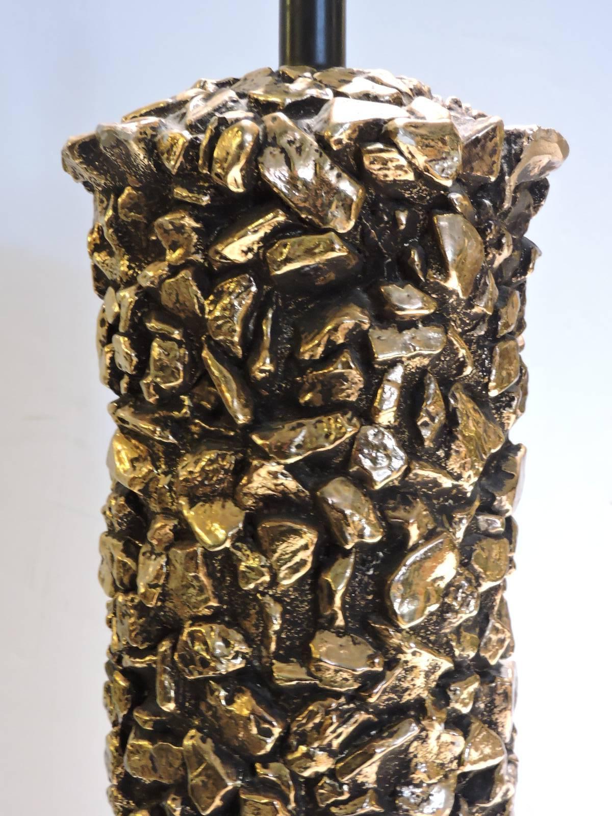  Tall cylindrical form plaster table lamp with all-over faux rock pebbles design in finely detailed original gilded and burnished surface. Circa 1960. Great looking lamp. Look at all pictures and read condition report in comment section.