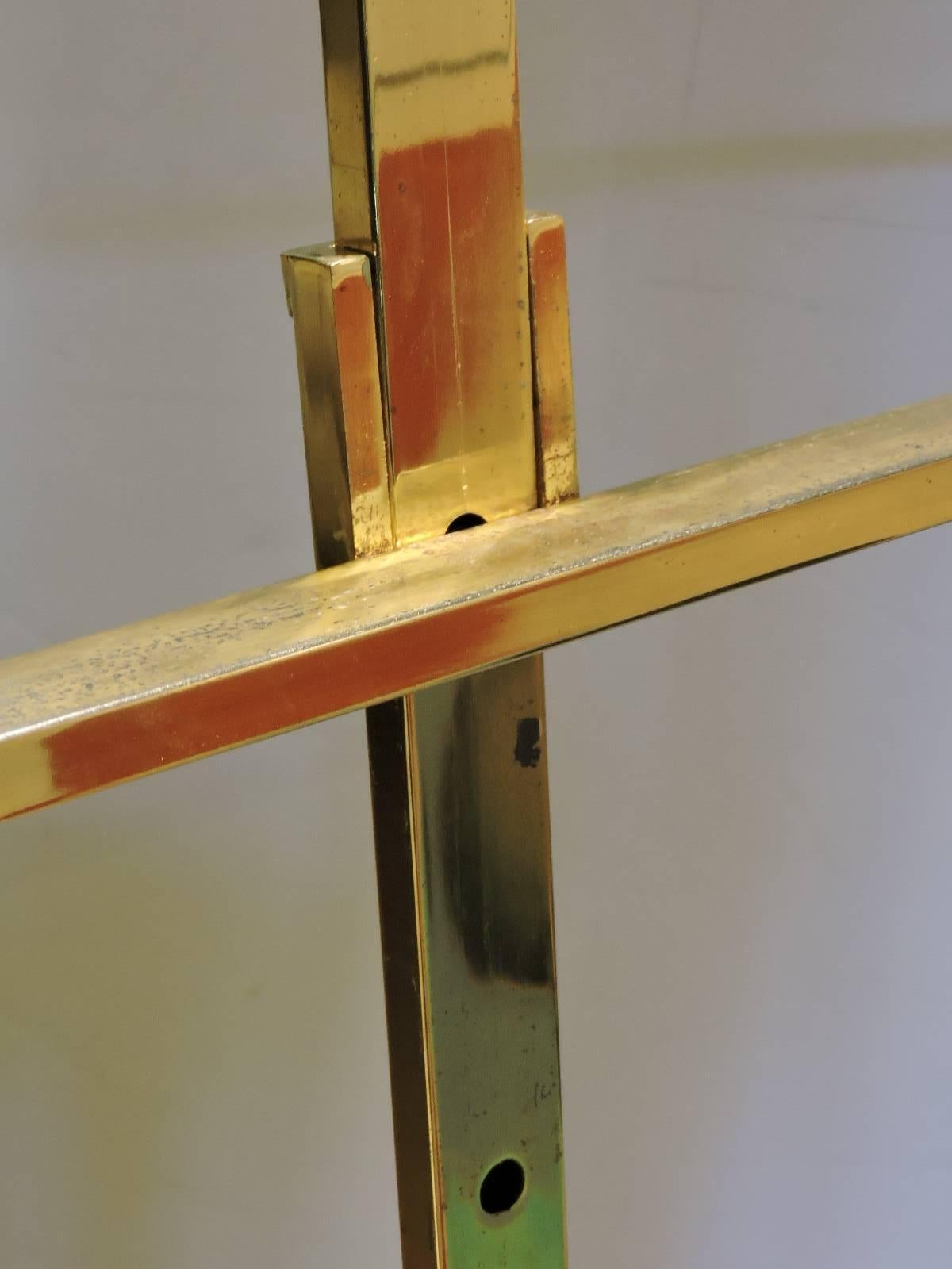 Adjustable brass floor easel by DIA - Design Institute of America - with a streamlined modernist form and four height settings for front shelf ( lowest is 26 inches - highest is 44 inches) DIA tag on underside of shelf - circa 1960-1970. See all