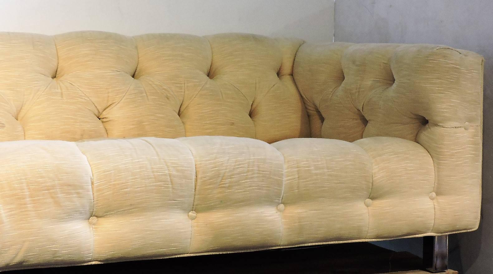 Milo Baughman attributed even arm tuxedo sofa raised on four wide rectangular chrome legs in original silky textured ivory cotton velvet button tufted custom upholstery. Very good quality heavyweight construction, circa 1970.