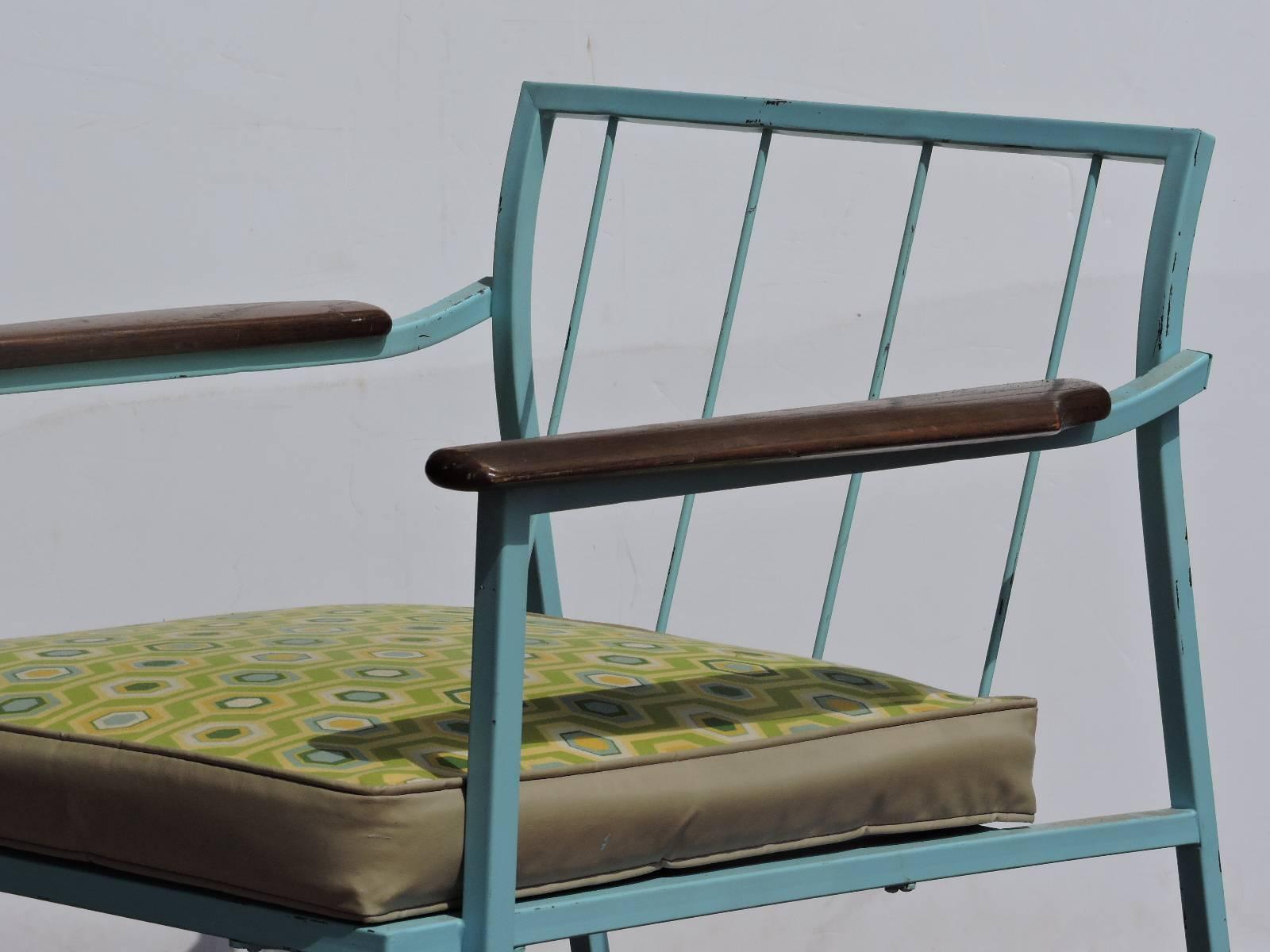 Pair of mid-20th century modernist sleek exaggerated square hollow stock iron frame armchairs in nicely aged original robins egg blue painted surface and  sculpted grained wood armrests. For porch patio or interior. Great looking chairs,