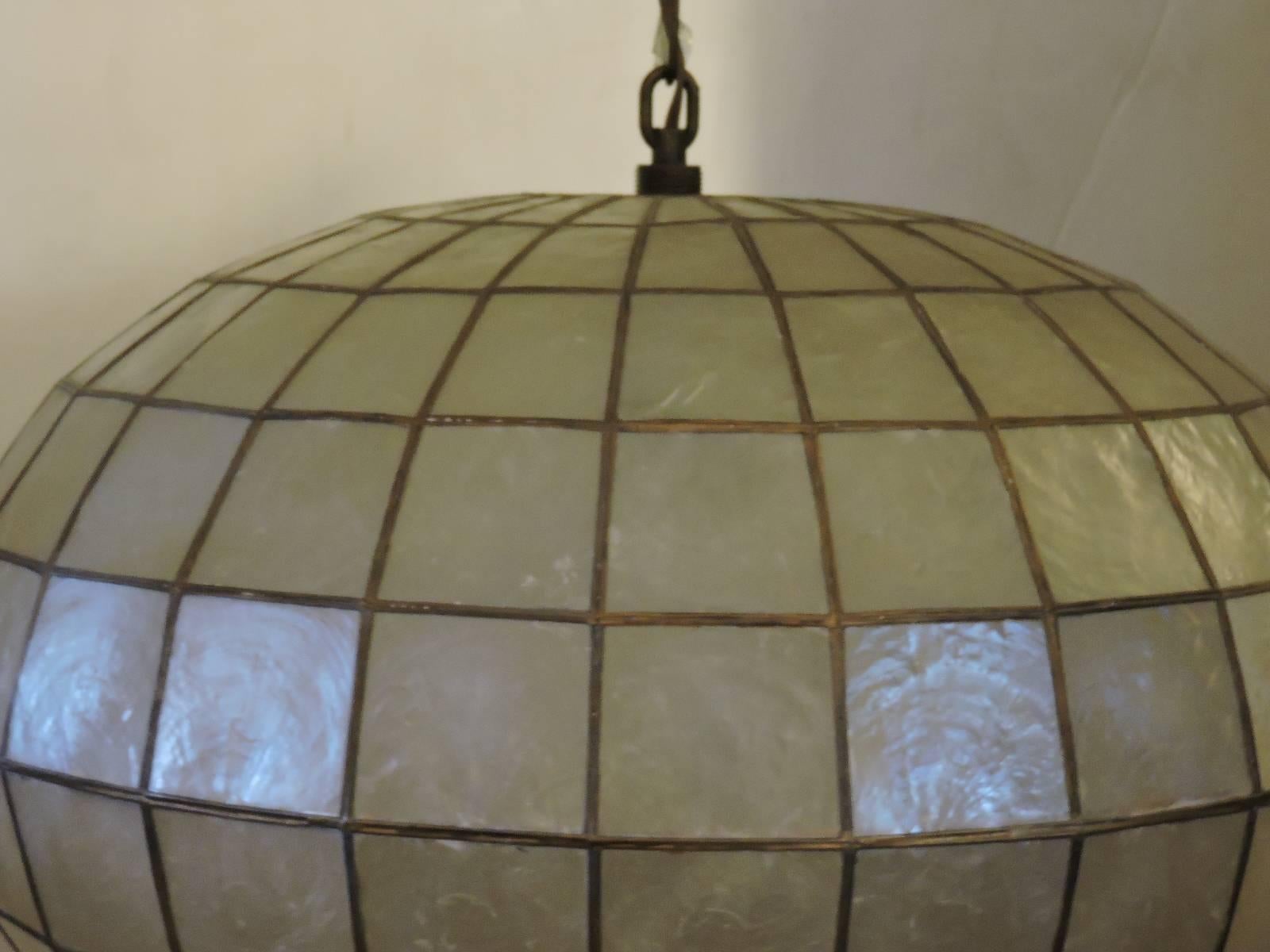 A large Minimalist architectural spherical form faceted Capiz shell hanging pendant chandelier light with two interior bulb sockets. Overall in great vintage working condition. Very good quality possibly by Feldman lighting company, circa 1960. See