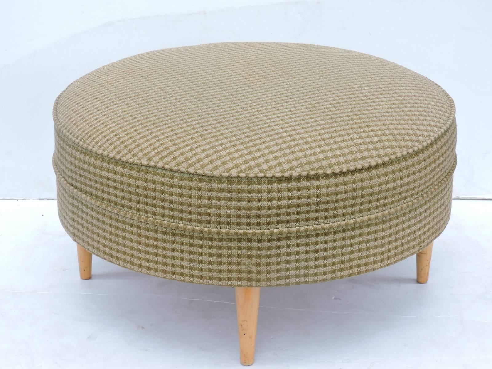  Large mid 20th century ottoman pouf with four round tapered maple legs and a wide and deep round upholstered seat in textured vintage woven hounds tooth fabric. Look at all pictures and read condition report in comment section.