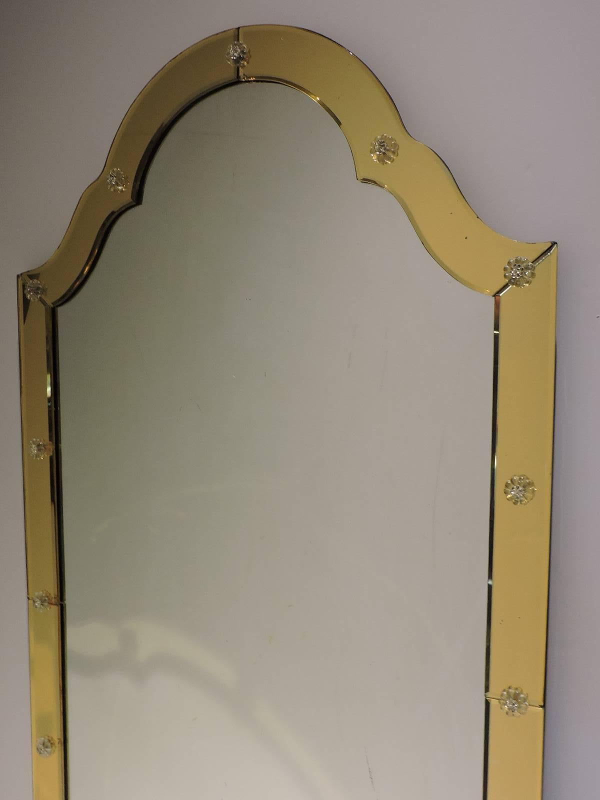 A beautiful Minimalist designed scrolled archtop golden amber Venetian glass mirror with clear rosette decorated framework. Very good quality, circa 1960s.