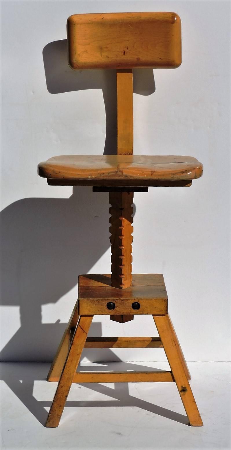Golden solid maple wood adjustable position Industrial sculptors work stool with a shaped seat that can be moved forward and backward by loosening bolts on frame / a seat height that can raised up and down by loosening bolts on frame / top back rest
