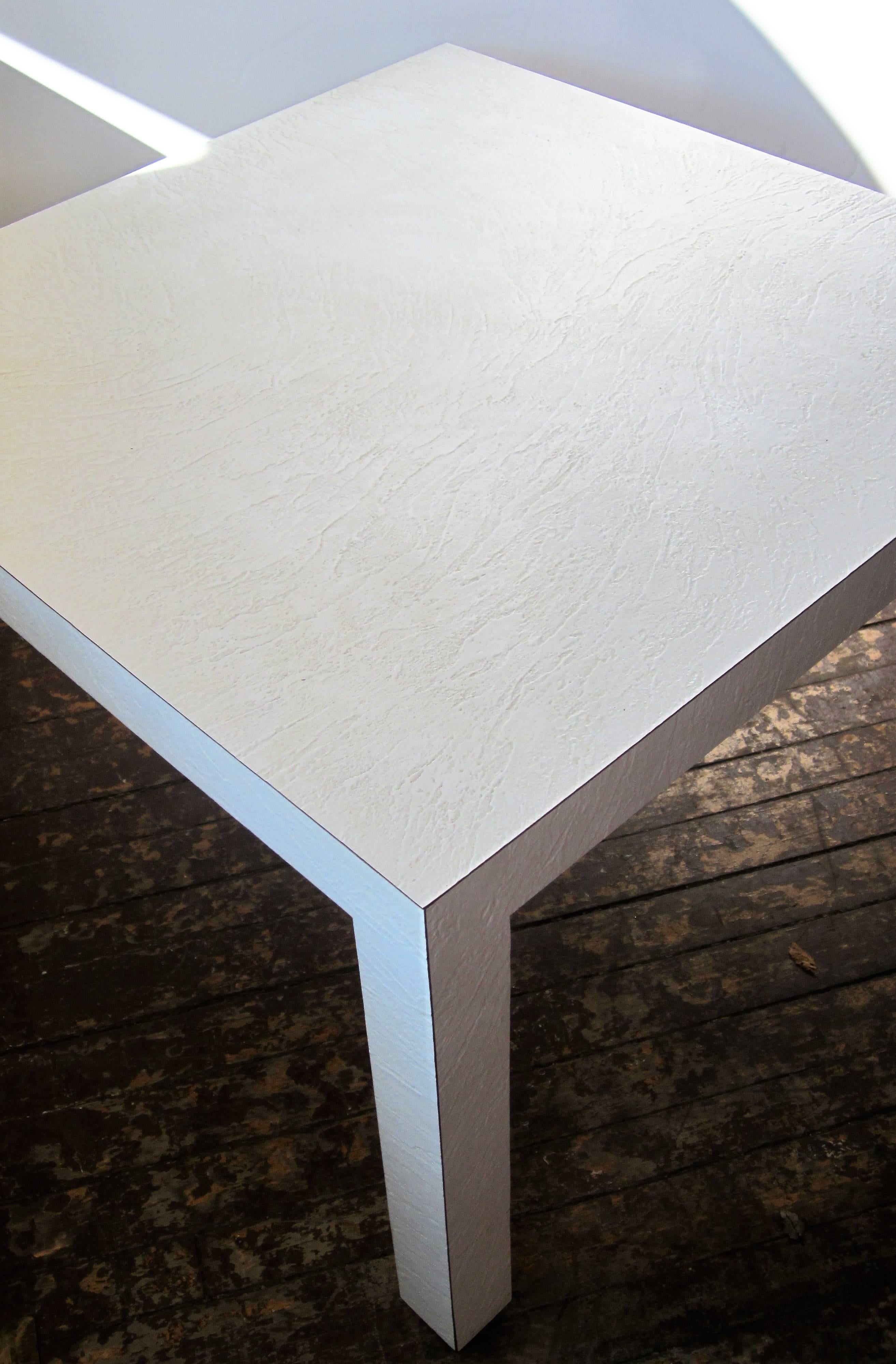 Custom-made textured white laminate parsons table, circa 1970s measuring 32 inches square x 21 inches high.