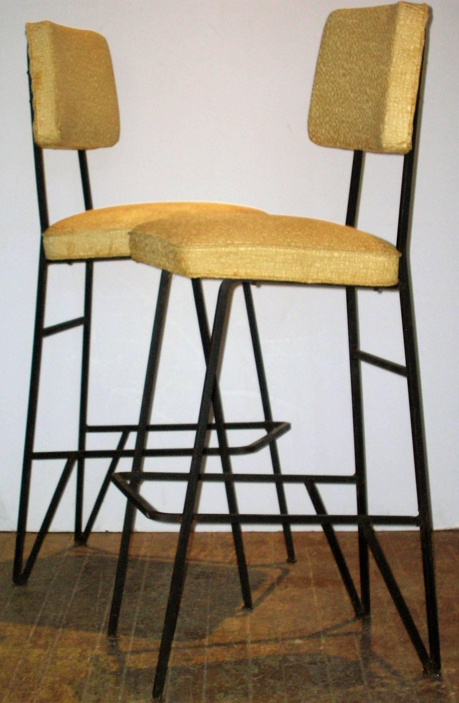 Set of four matching iron counter stools or bar stools with a beautifully designed angular architectural form in the style of Frederick Weinberg. Solid heavyweight high quality construction. Very stable comfortable seating.  Great looking 100% all