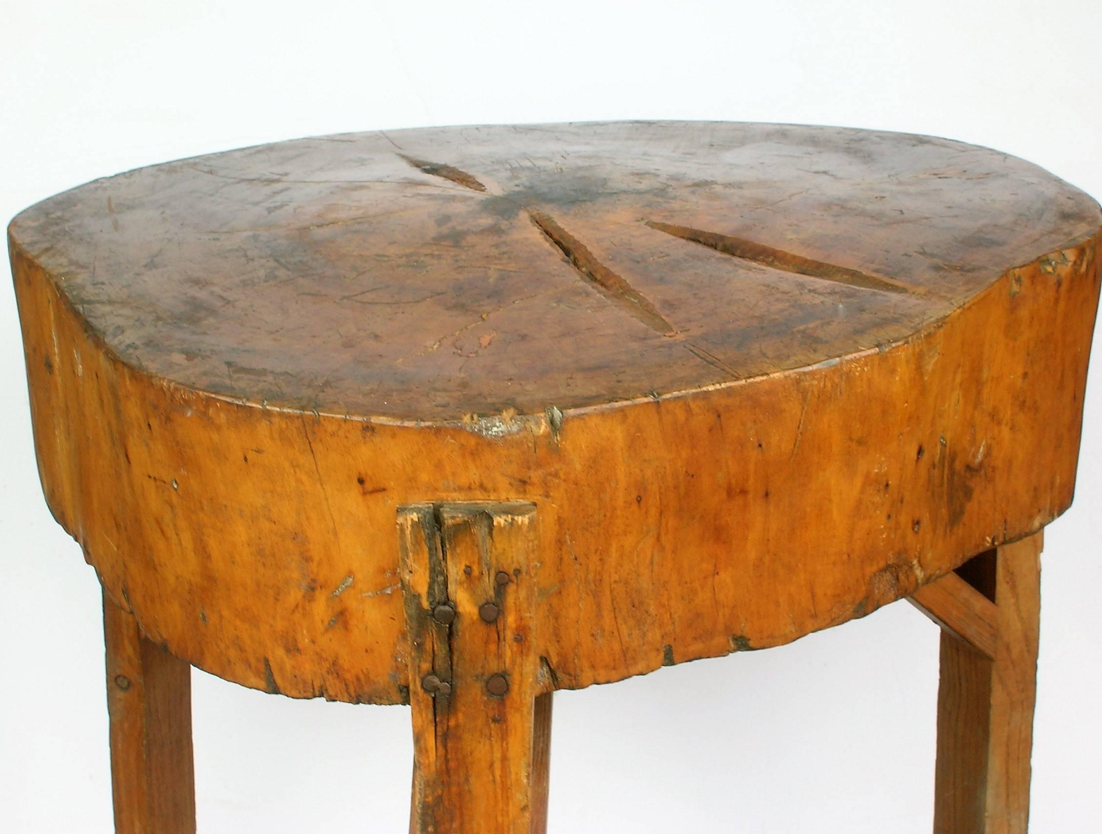 Antique American primitive three-legged butcher block table with perfectly aged rich glowing color patina and an asymmetrically shaped natural organic sculptural form. Beautiful table.