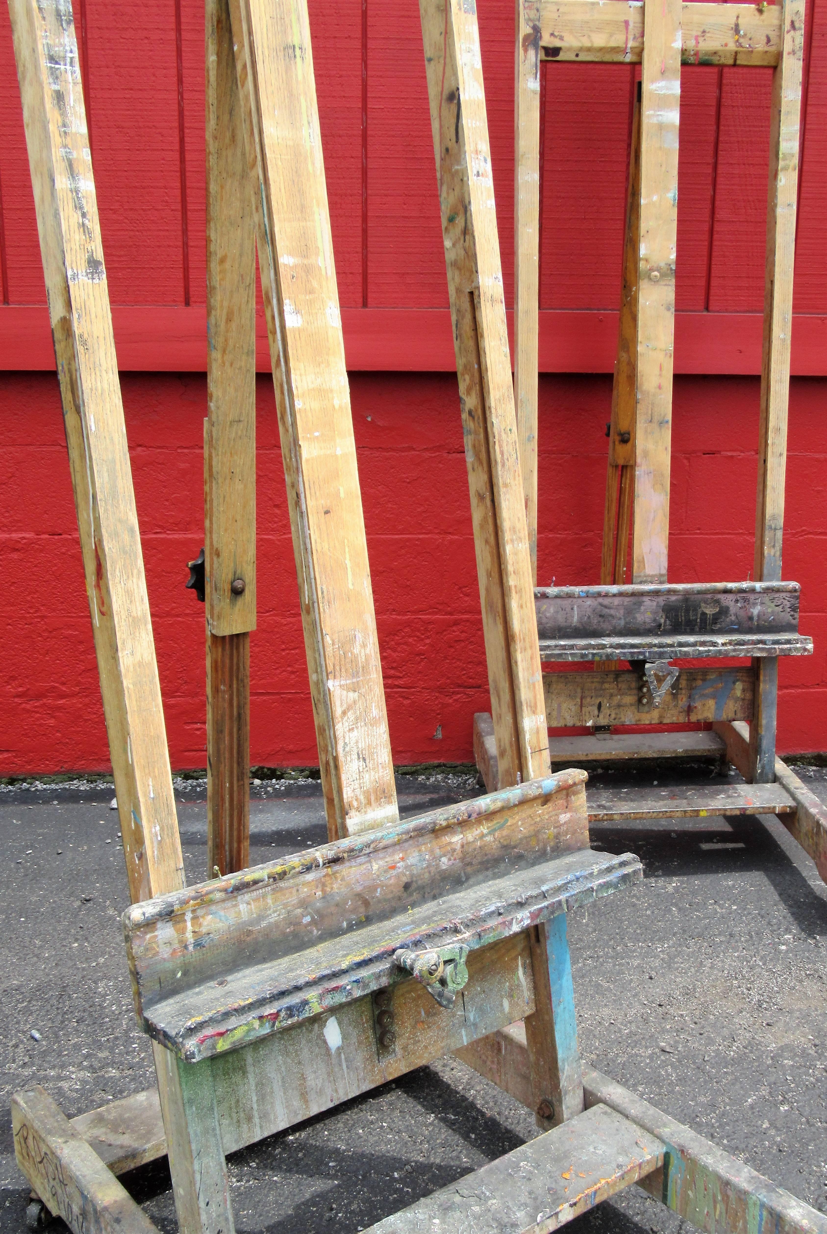 Two matching large oak adjustable height rolling painters easels in old surface with years of paint build up. Very good quality nice working easels in the old masters style, circa 1960s. See all pictures.