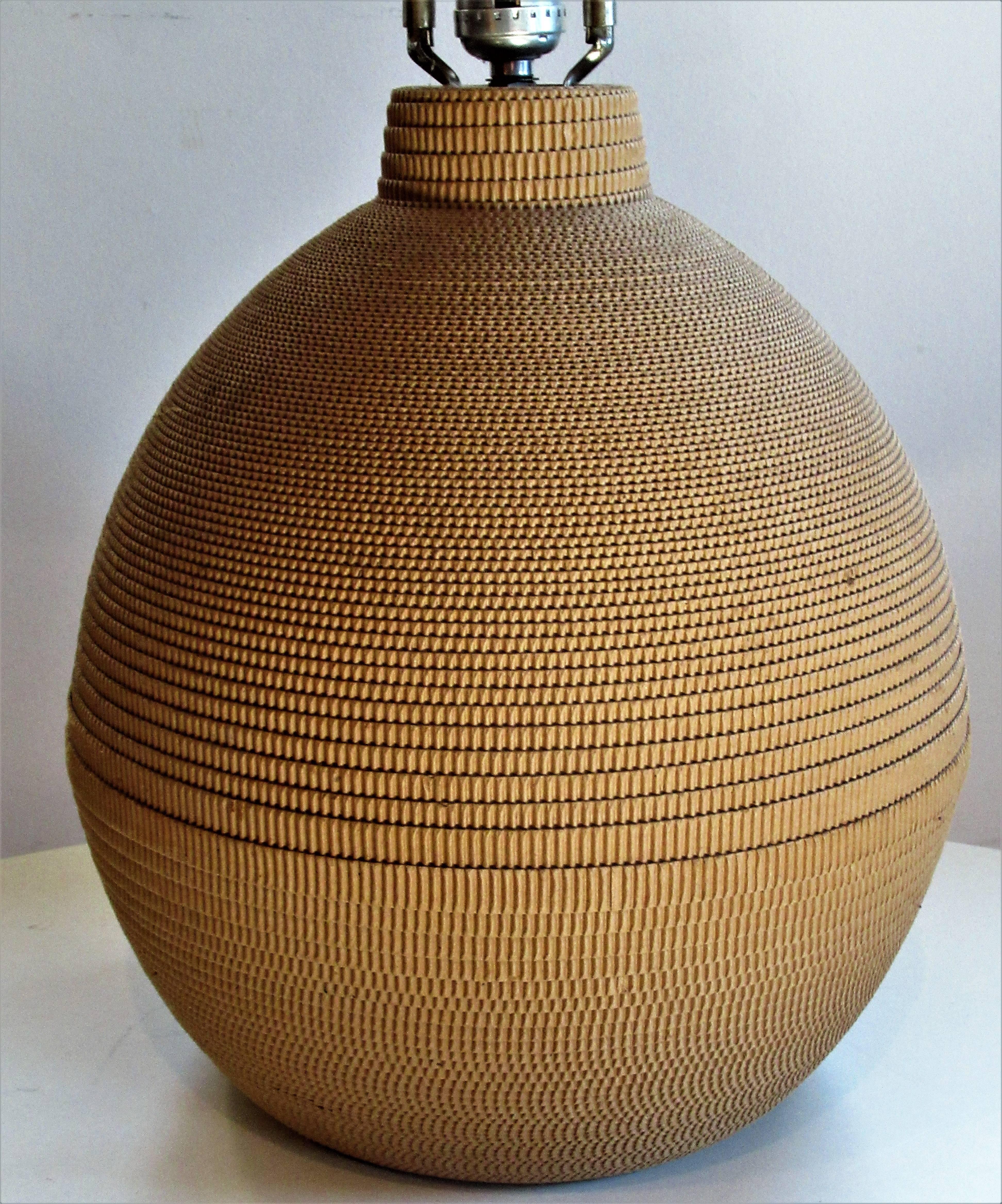 Dating from the 1970s a great looking corrugated cut spiral paper bulbous form table lamp in the style of Frank Gehry.