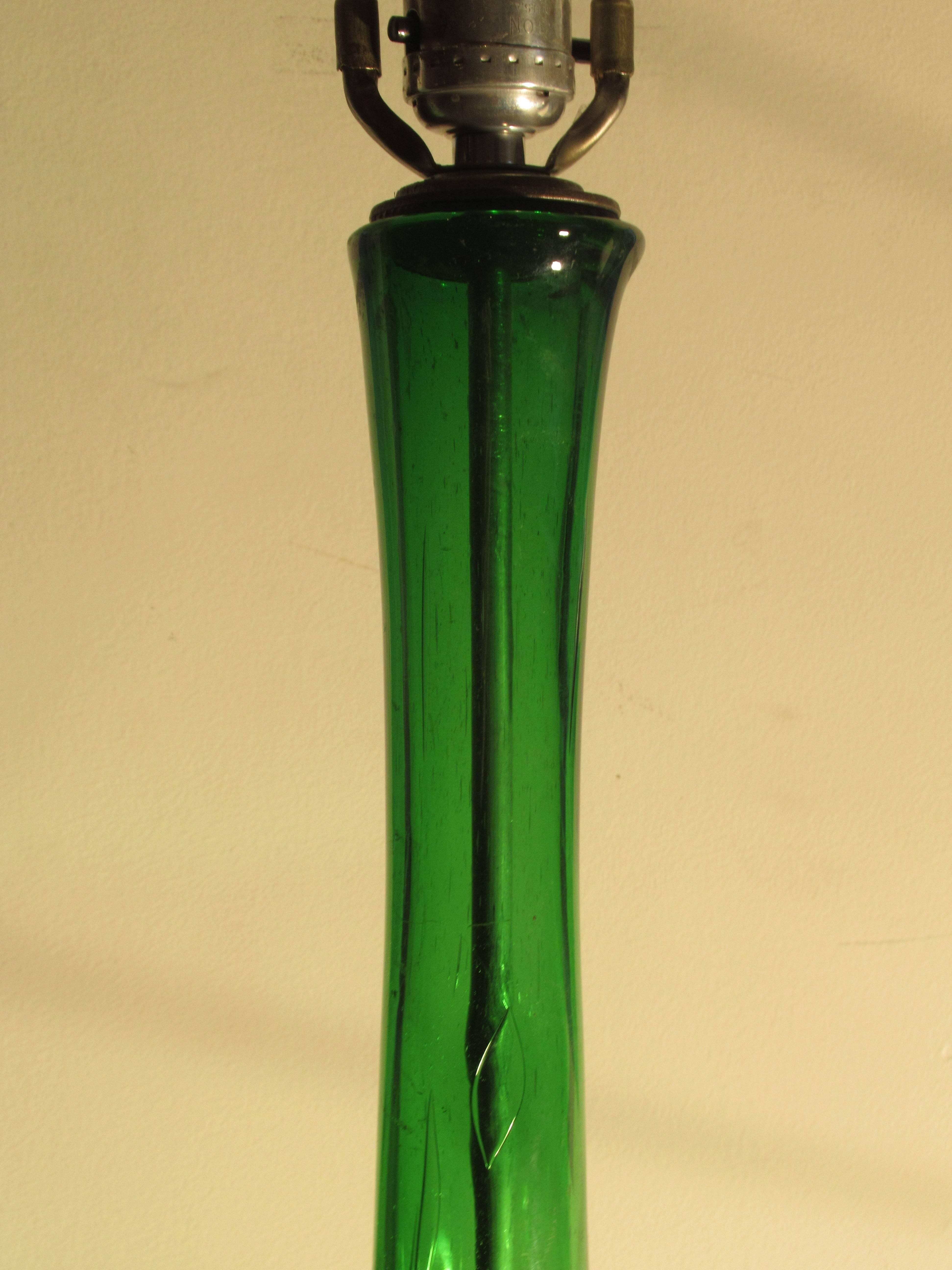 An antique oversize sculptural blown glass demijohn style bottle lamp with an elongated neck / nice bubbling and brilliant light emerald green color. Appears to have been constructed in the 1940s (yet glass may be older). See all pictures. Best one
