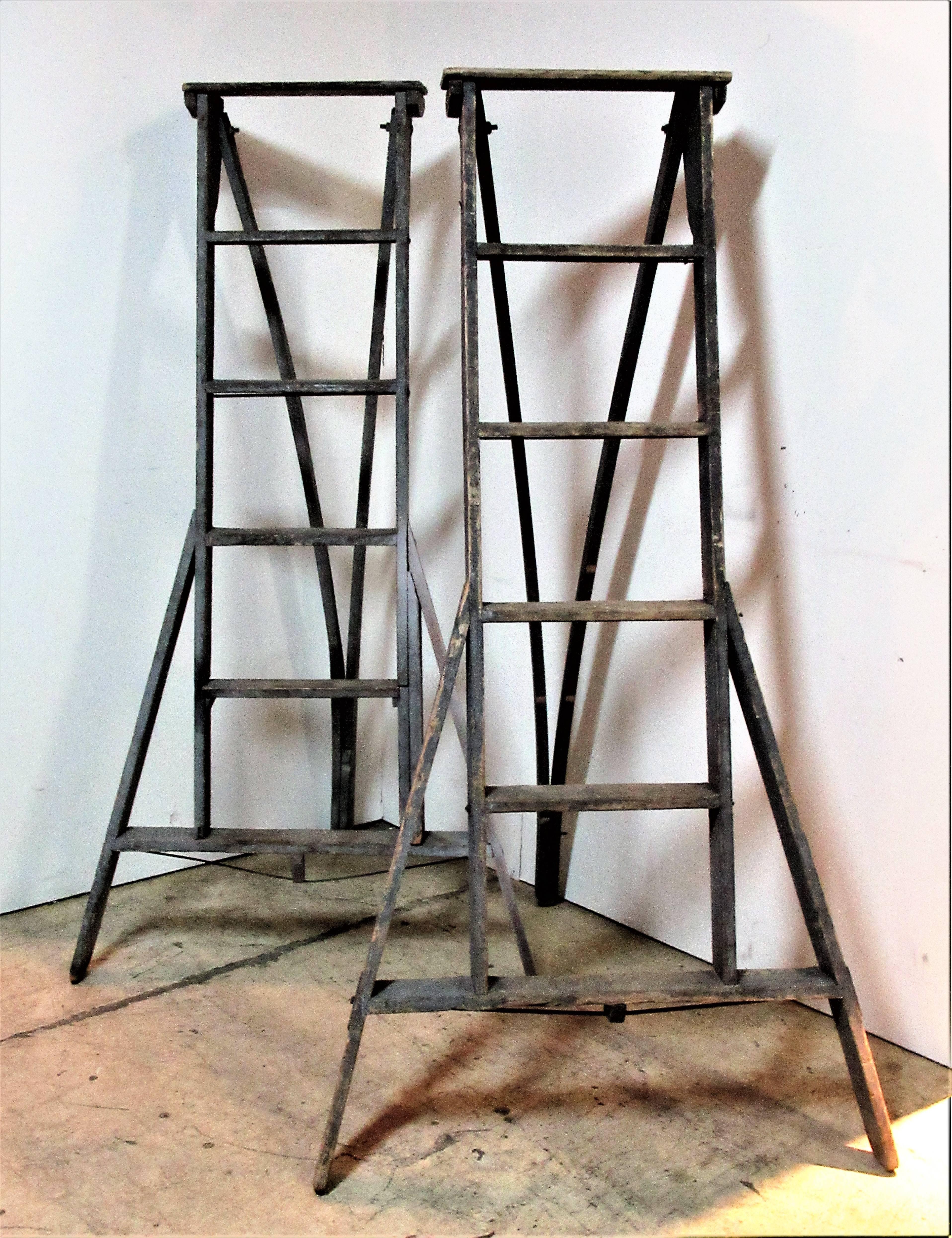 Two antique American wood & metal riveted apple fruit picking ladders in great old original dry dark slate gray and lighter gray painted surface with beautiful naturally age weathered patina from years of use. Both are incise stamped signed with the