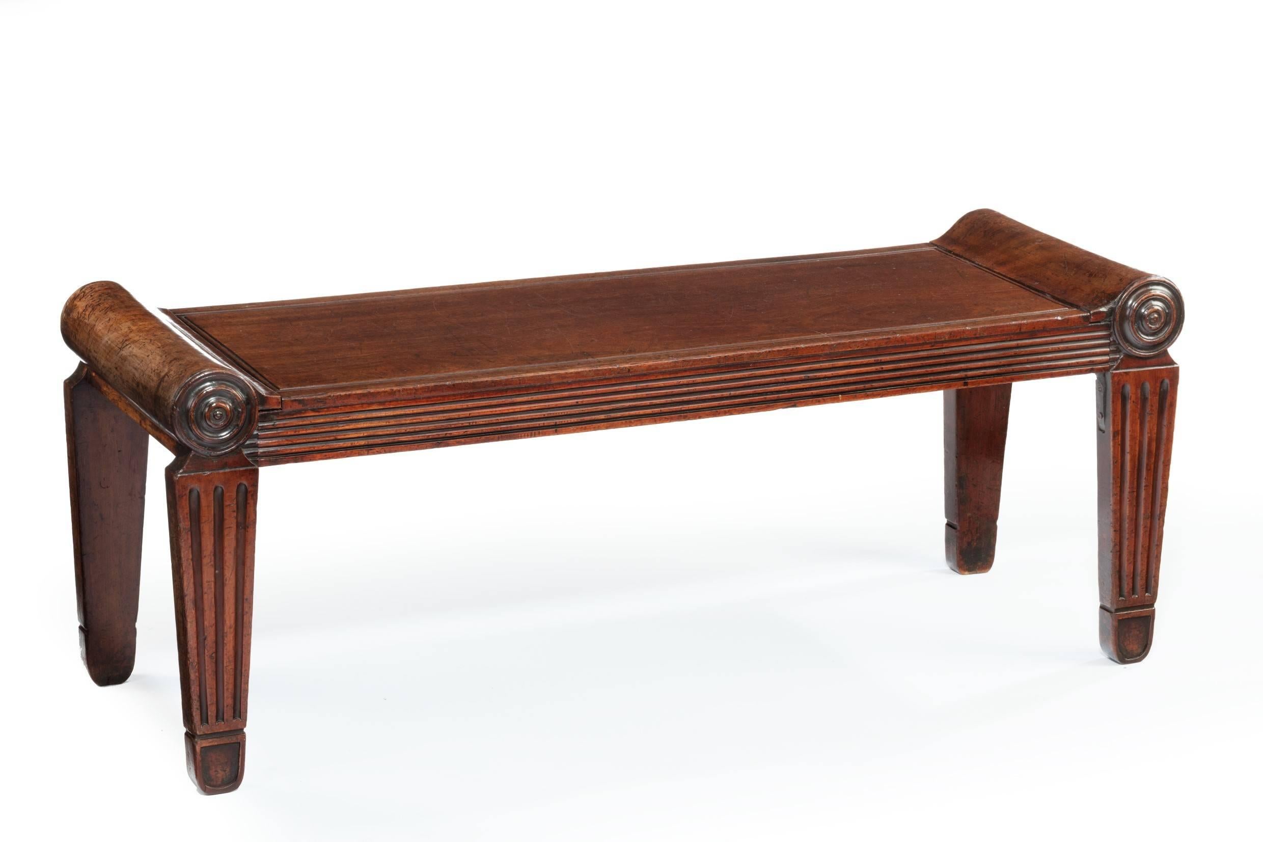 Very smart mahogany hall bench in the manner of Charles Heathcote Tatham. The Roman seat pattern. Issued in etchings of ancient ornamental architecture, 1799. Rectangular top bench with reeded frieze, tapered legs headed with roundels.
