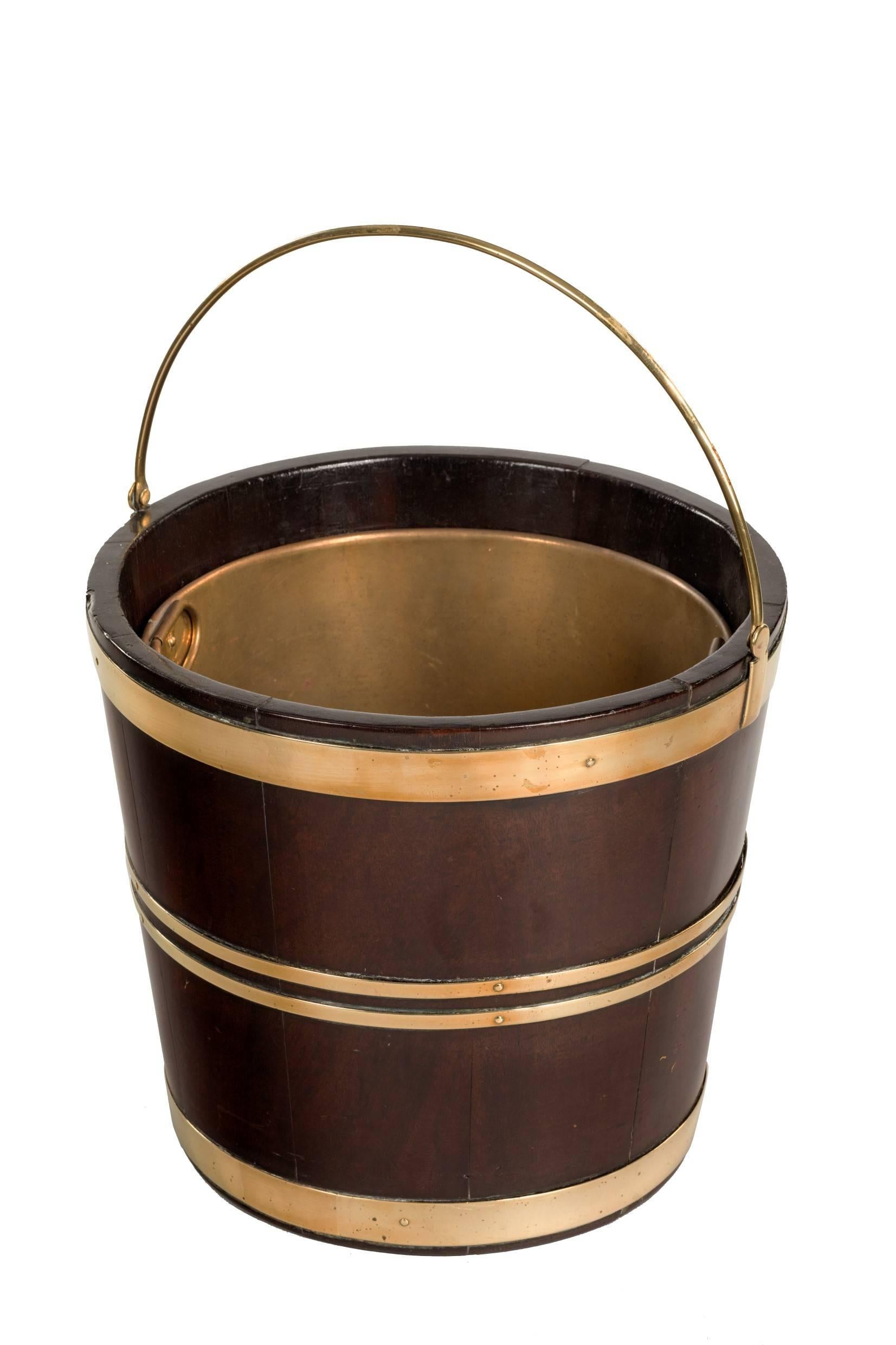 A very smart brass bound mahogany Dutch bucket with swing handle and later liner. Perfect as a planter.